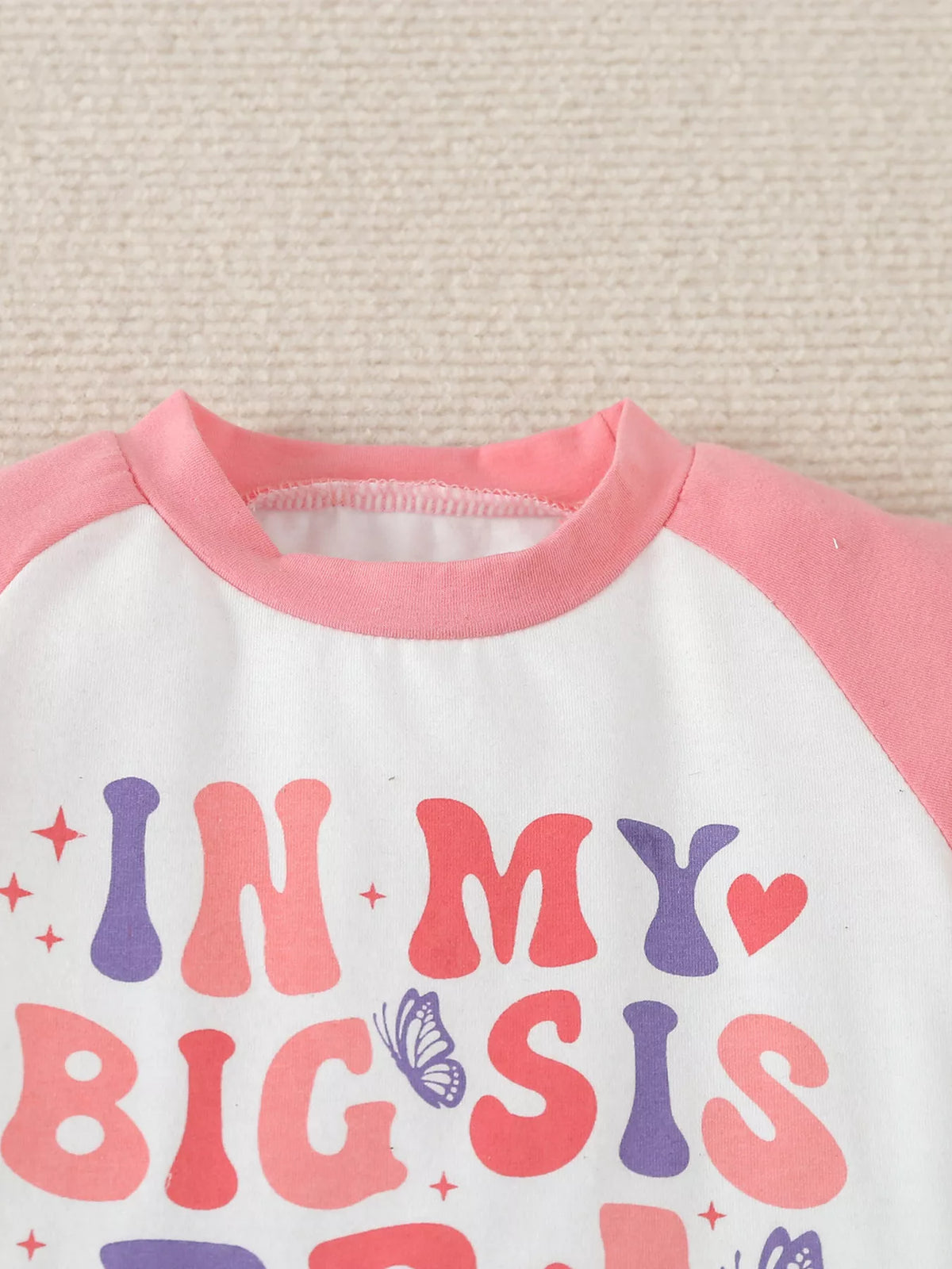 Pink neckline and colorful lettering