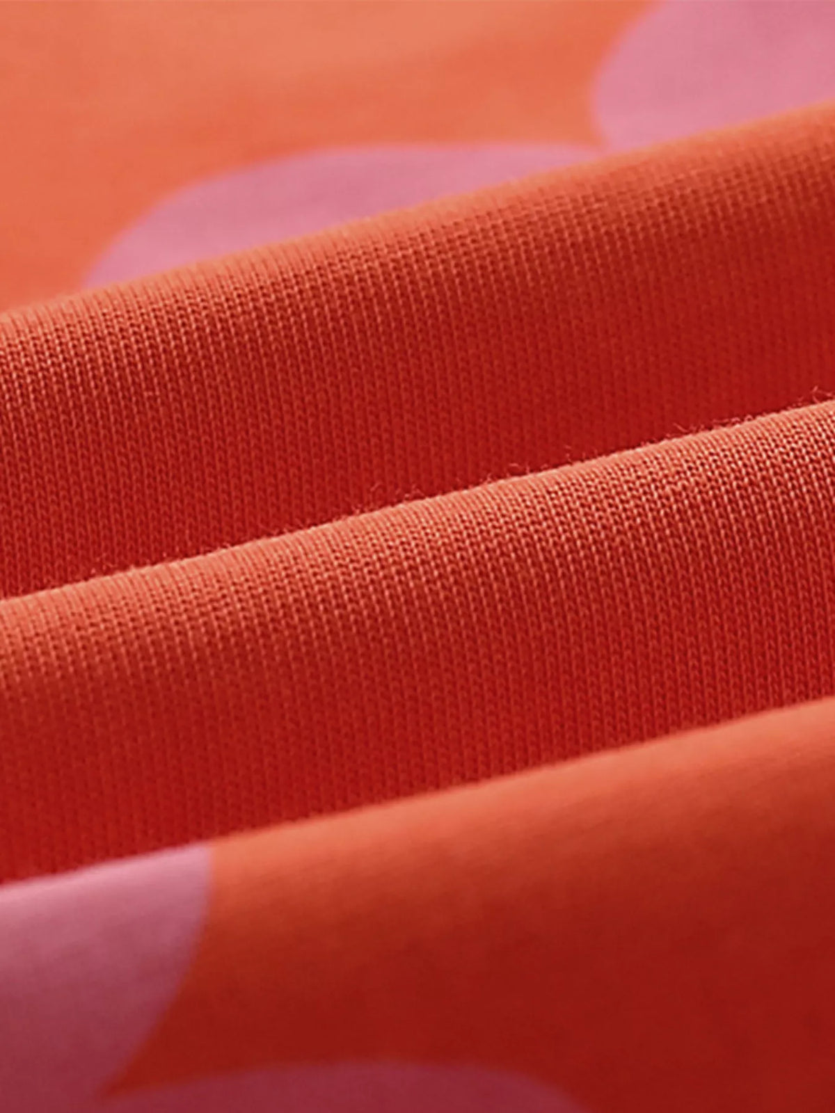 Orange-red fabric with pink flower print