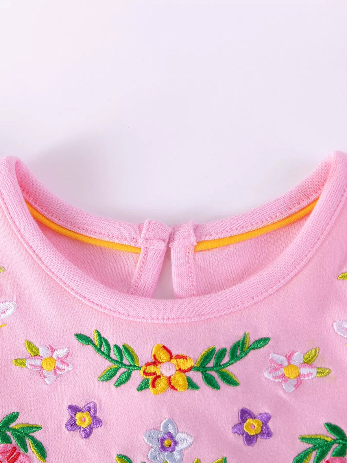 Round neckline and multicolored flower embroidery