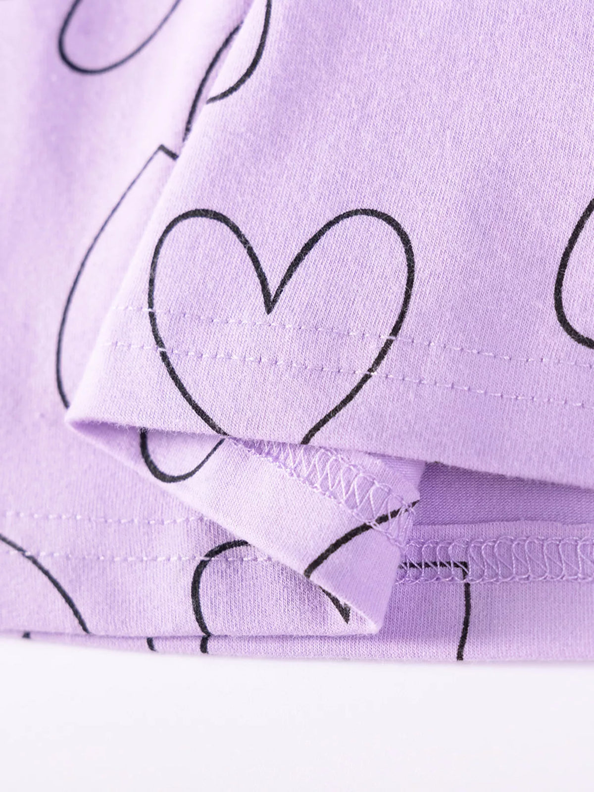 Inside stitching at the lavender heart-print hem