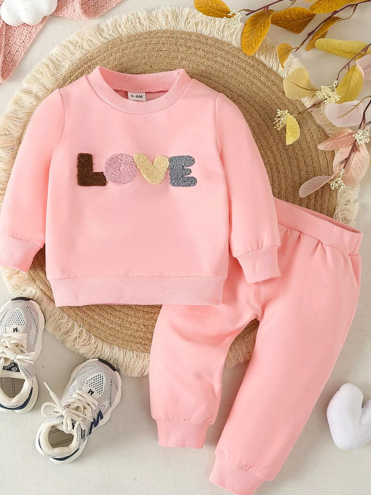Pink Love top and pants laid flat