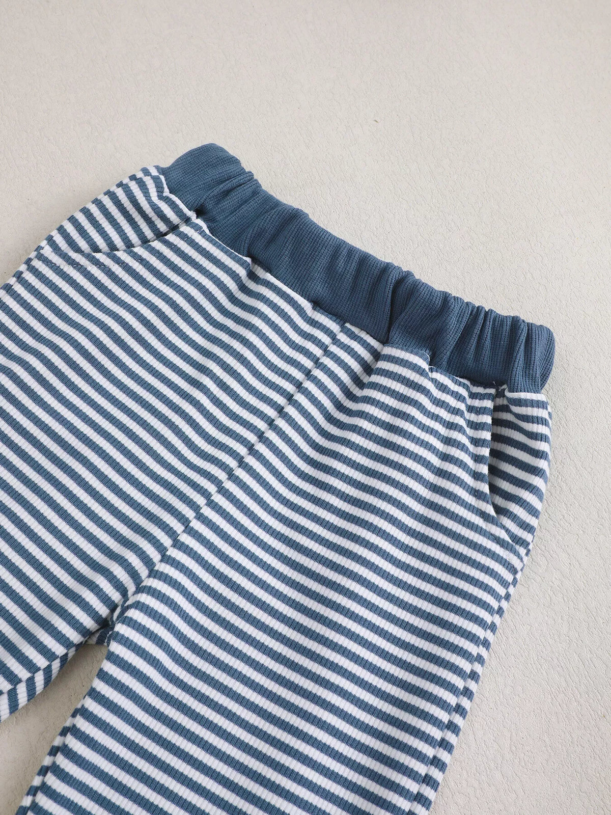 Navy elastic waistband on striped pants