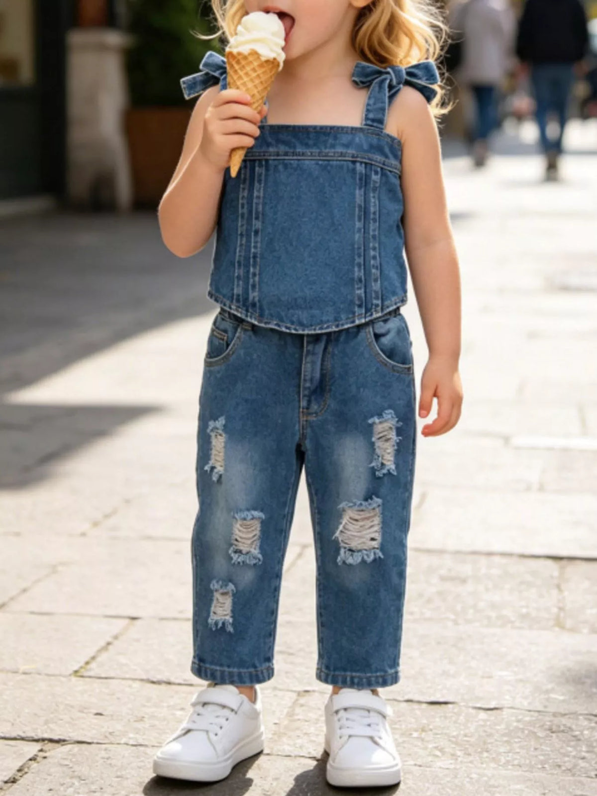 Denim tie-shoulder tank with distressed jeans on a child