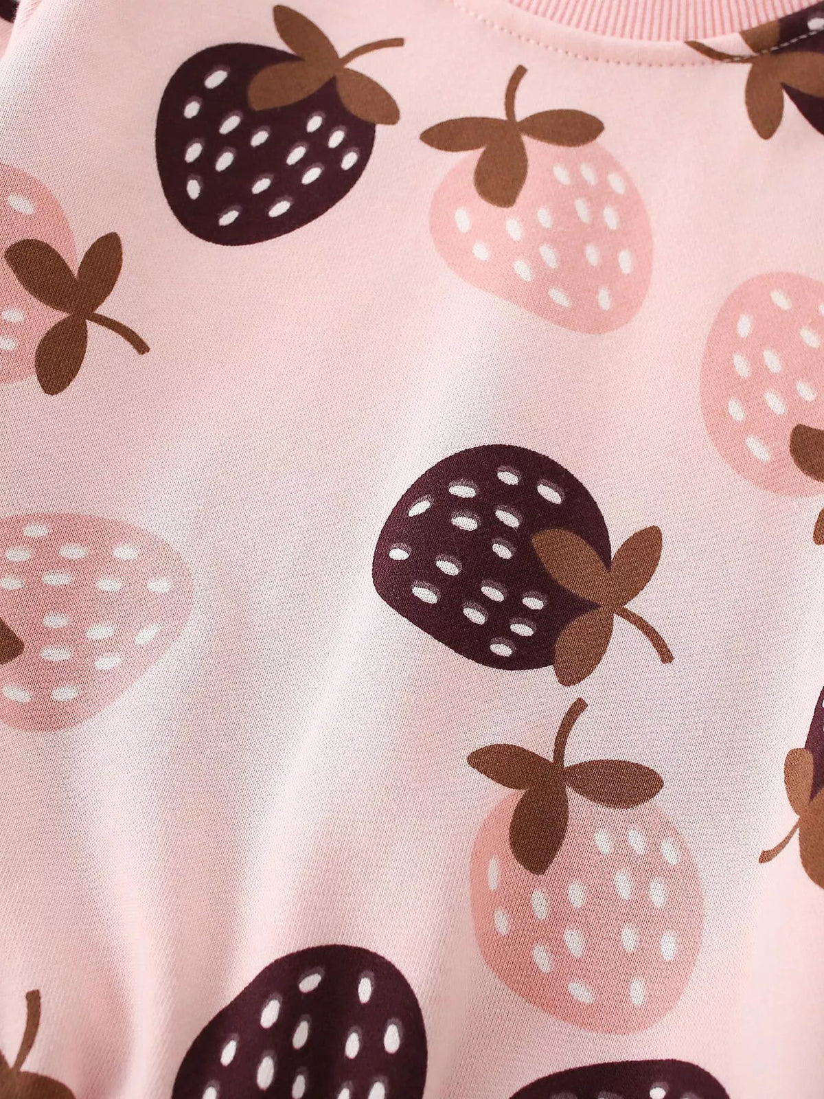 Dark and pale strawberry motifs on pink fabric