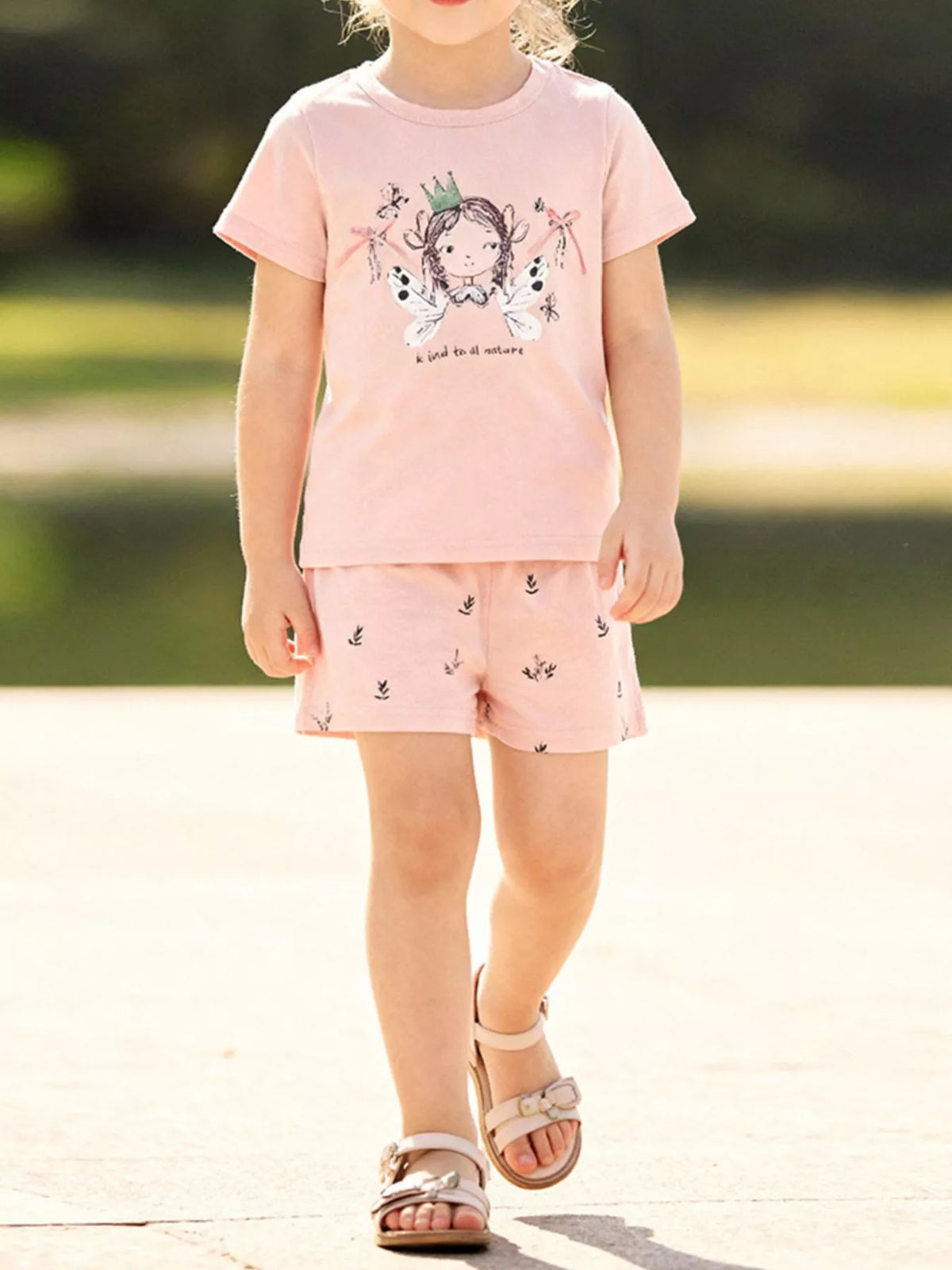 Peach fairy-graphic tee with small-print shorts on a child