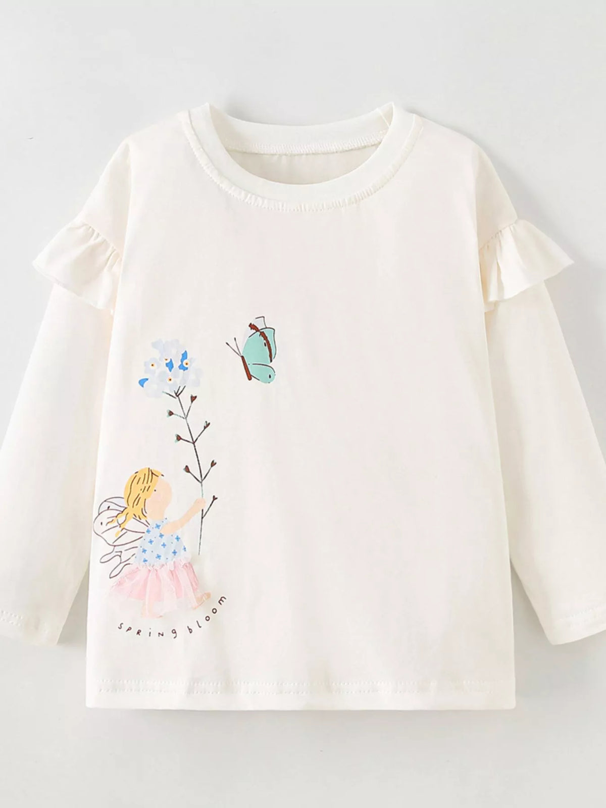 Cream fairy-graphic long-sleeve top with shoulder ruffles laid flat
