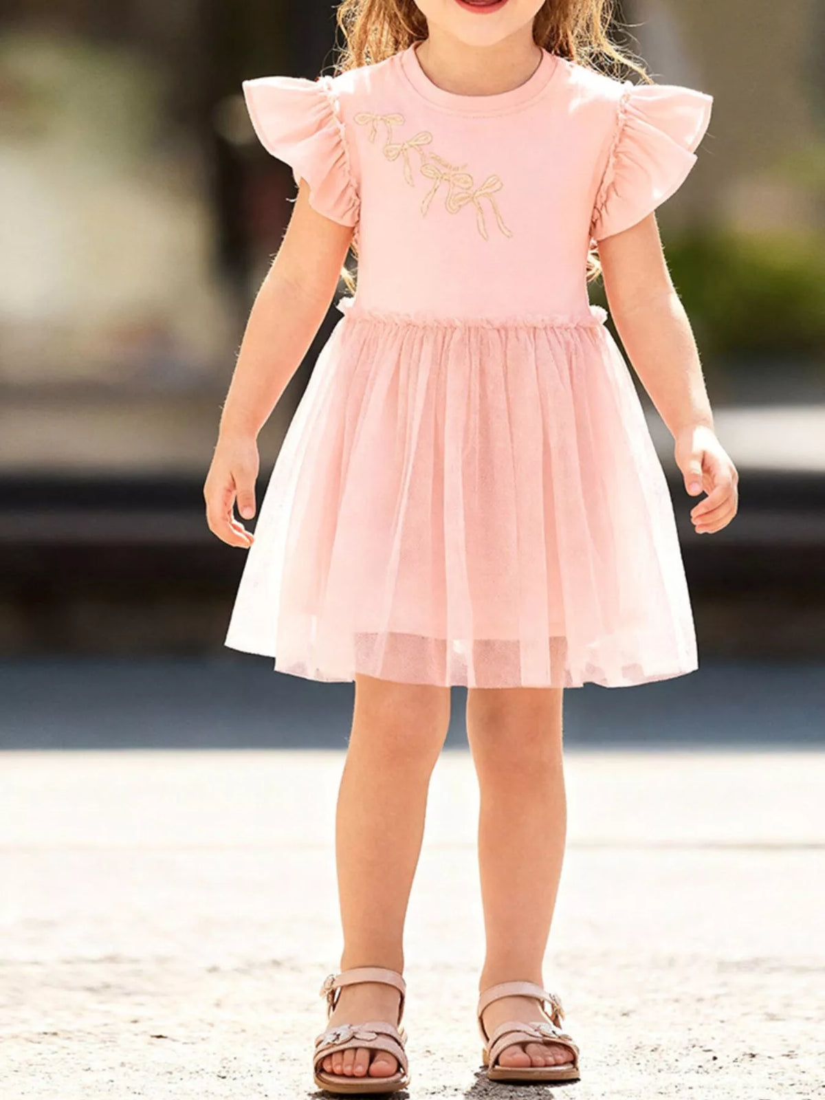 Peach bow-motif ruffle-sleeve dress with a tulle skirt on a child