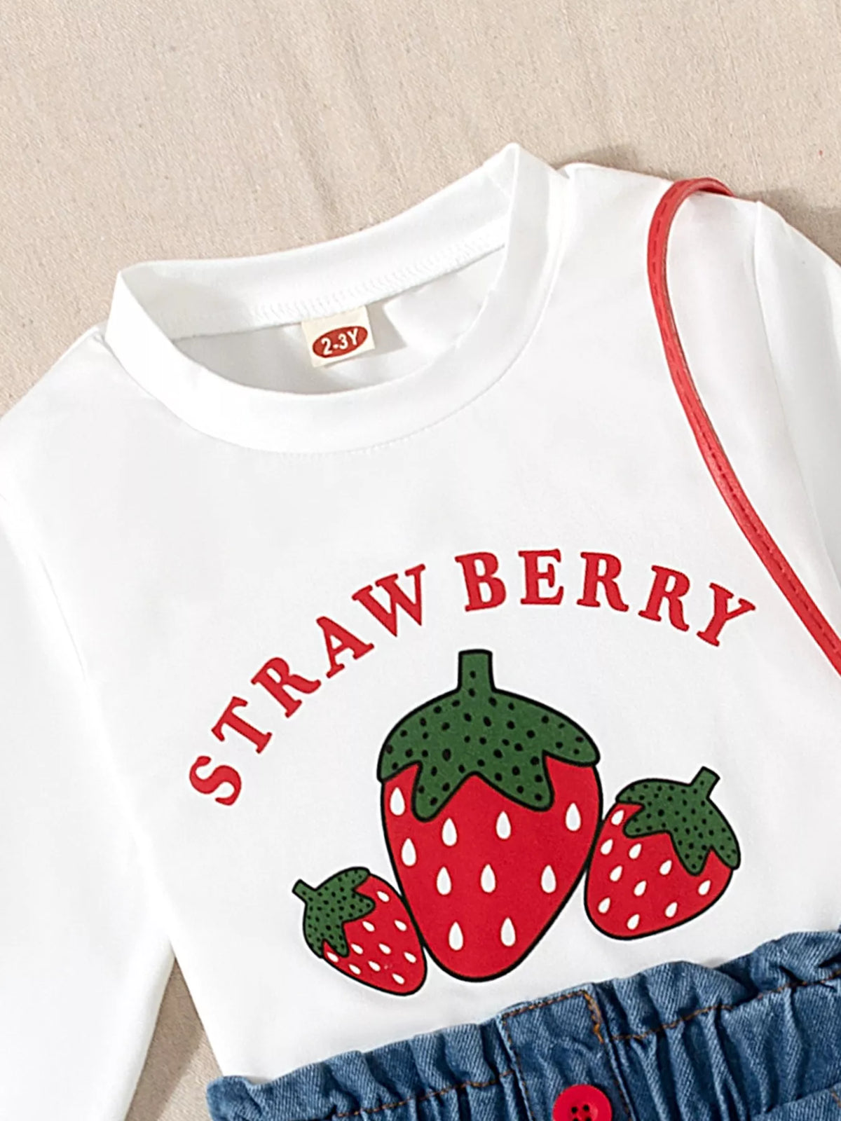 White round neckline and strawberry lettering