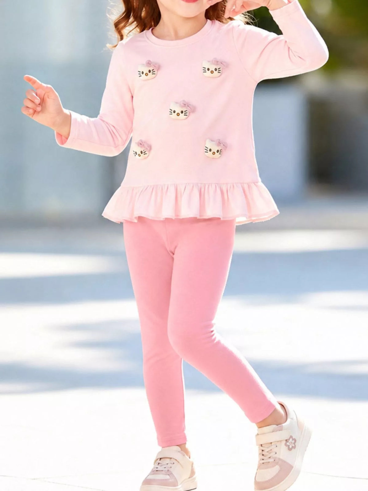 Outfit on a child with one hand raised