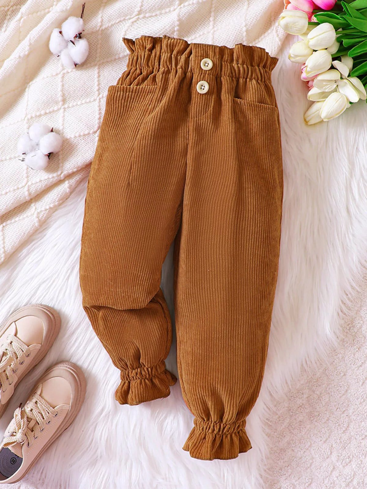 Caramel corduroy pants laid flat