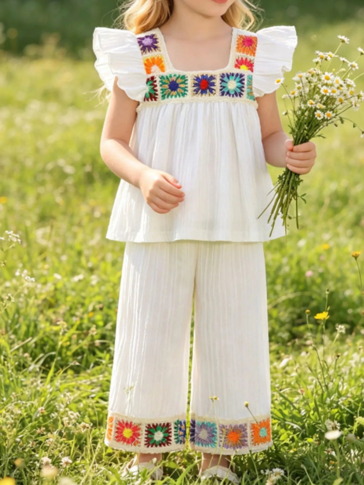 White crochet-trimmed top with wide-leg pants on a child