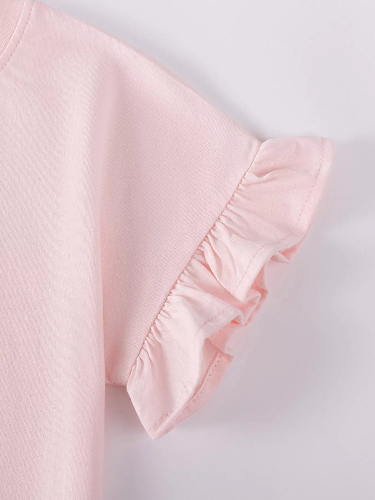Ruffled edge on the pink short sleeve