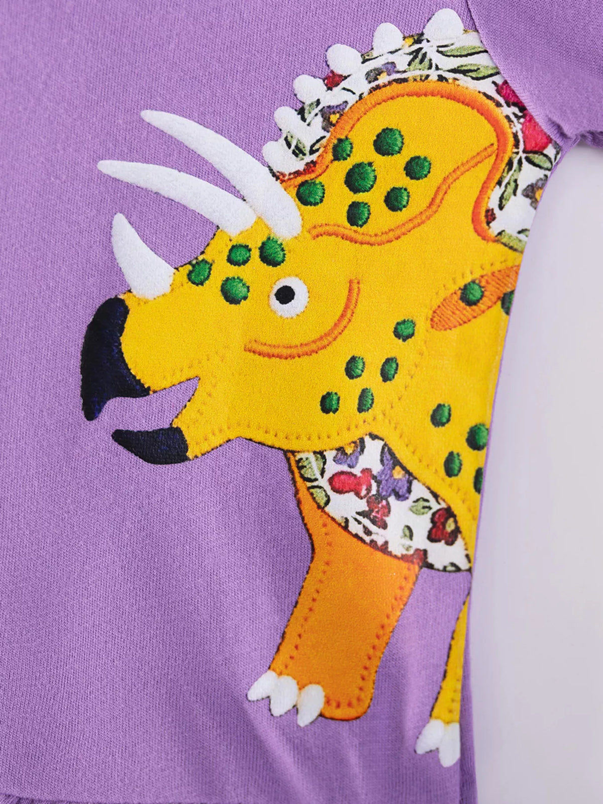 Yellow dinosaur applique with patterned frill