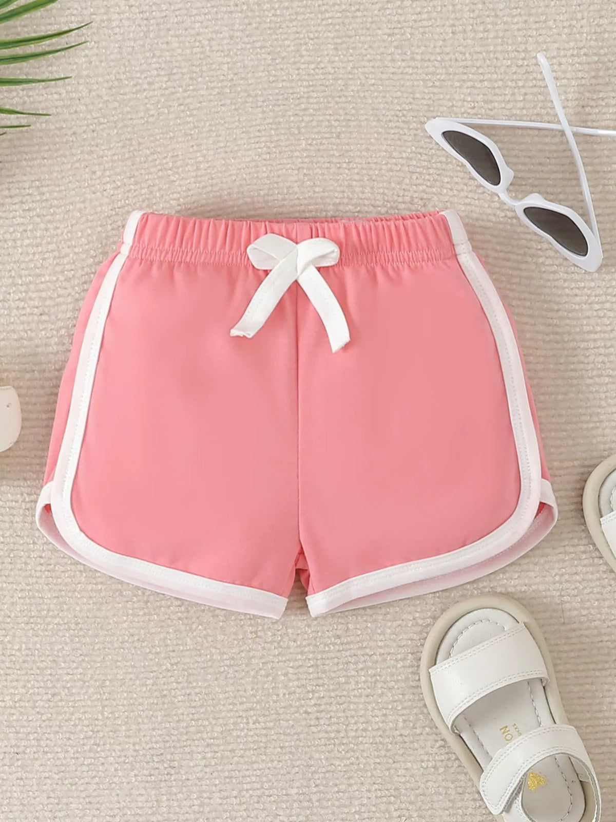 Pink shorts with white binding and drawstring