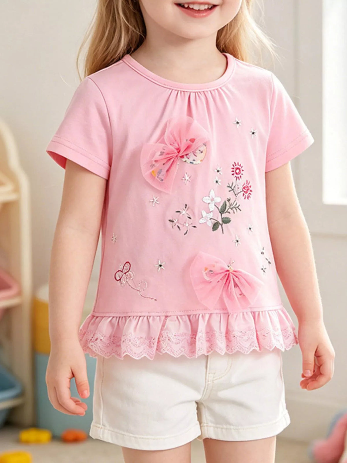 Pink floral embroidered tulle bow ruffle hem shirt — shirt shown on child
