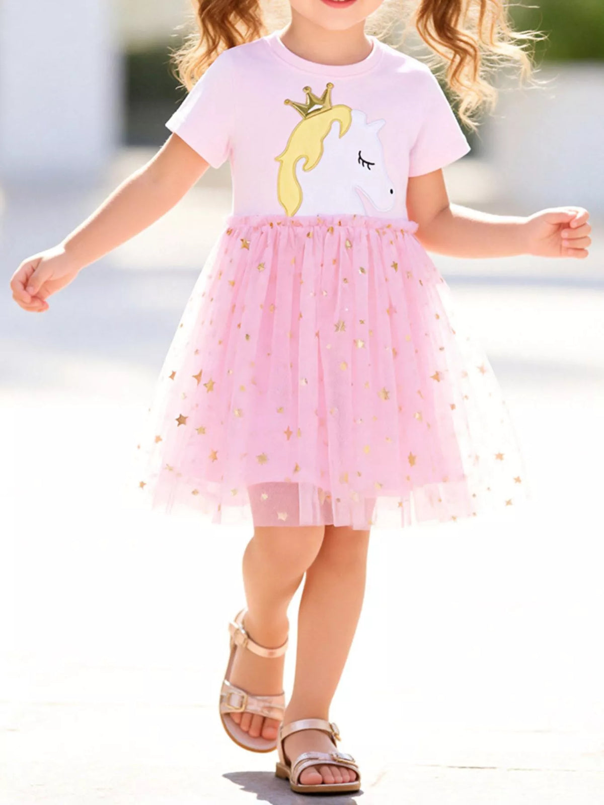 Pink crowned-unicorn dress with a gold-star tulle skirt on a child