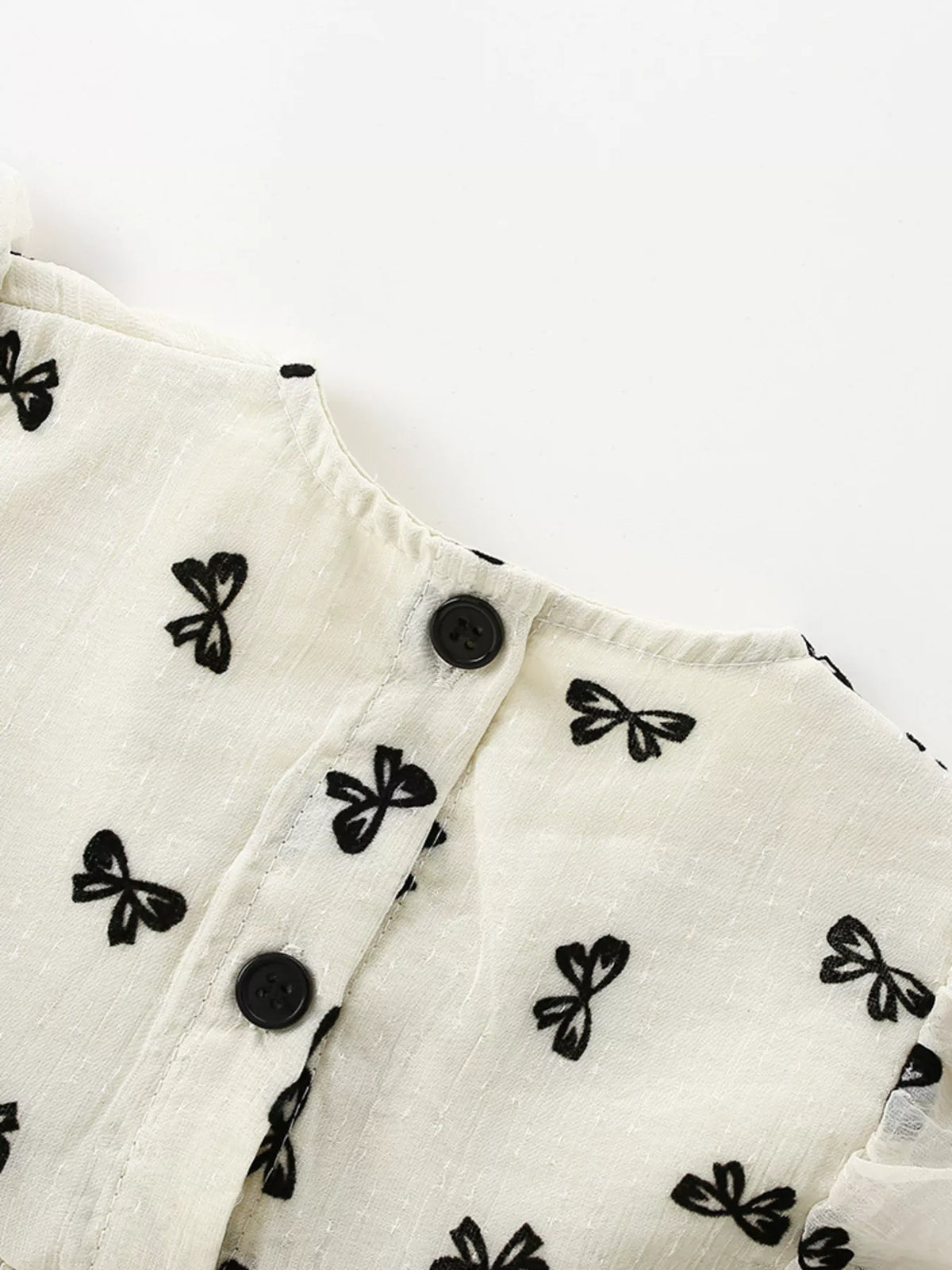Black buttons on the back opening