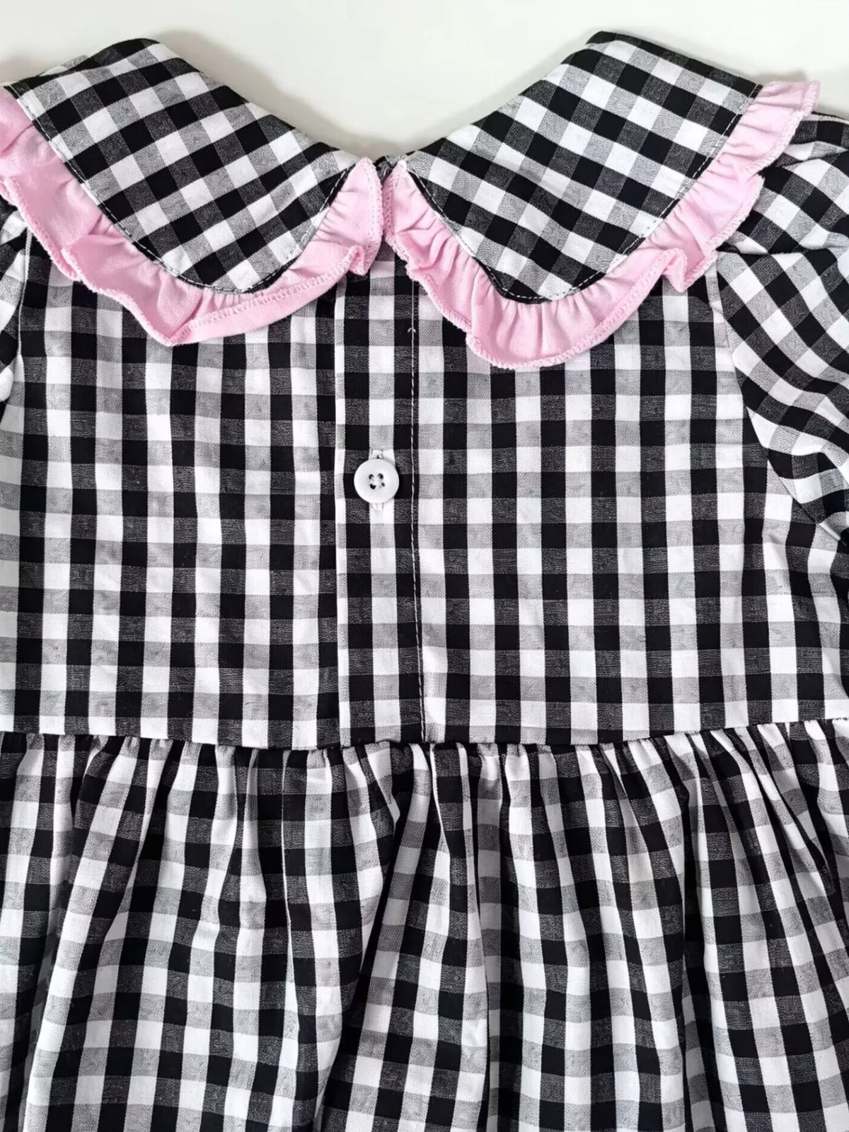 Back buttons on the gingham top