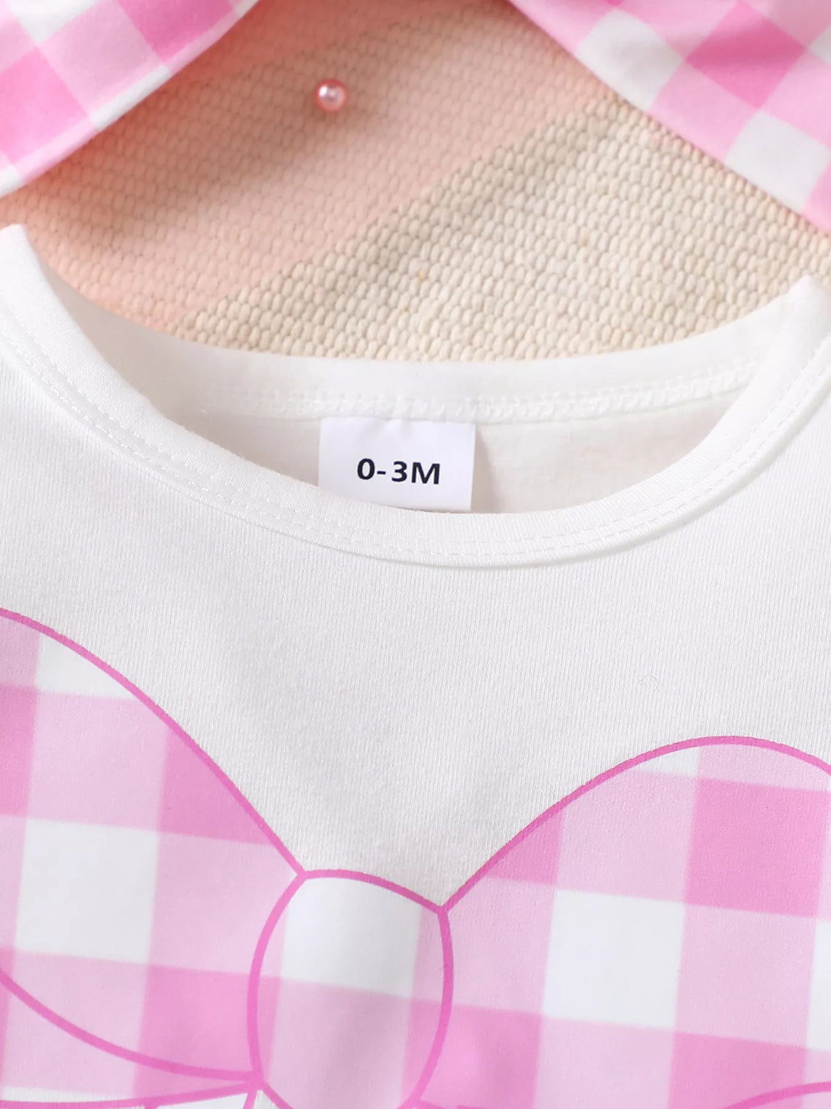 White neckline and pink gingham bow graphic