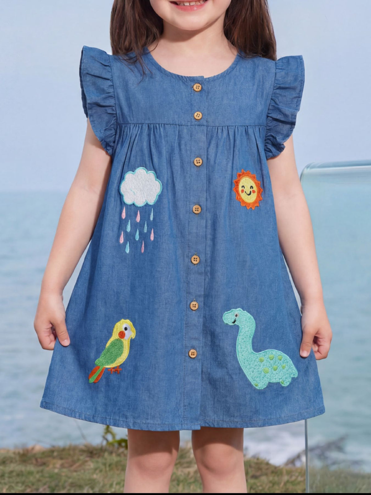 Dinosaur and Bird Embroidered Denim Dress — dress worn by a child