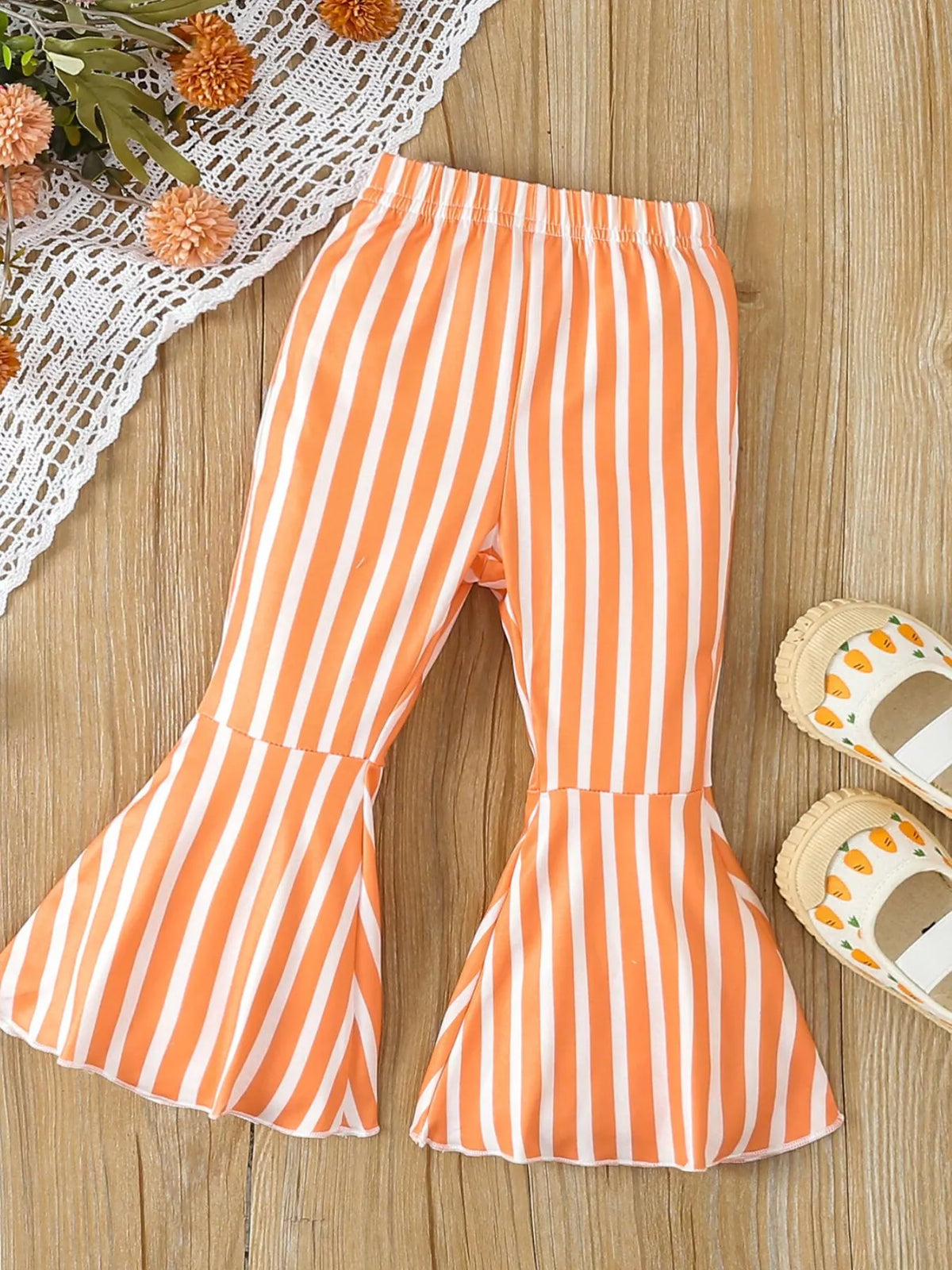 Orange striped flared pants laid flat