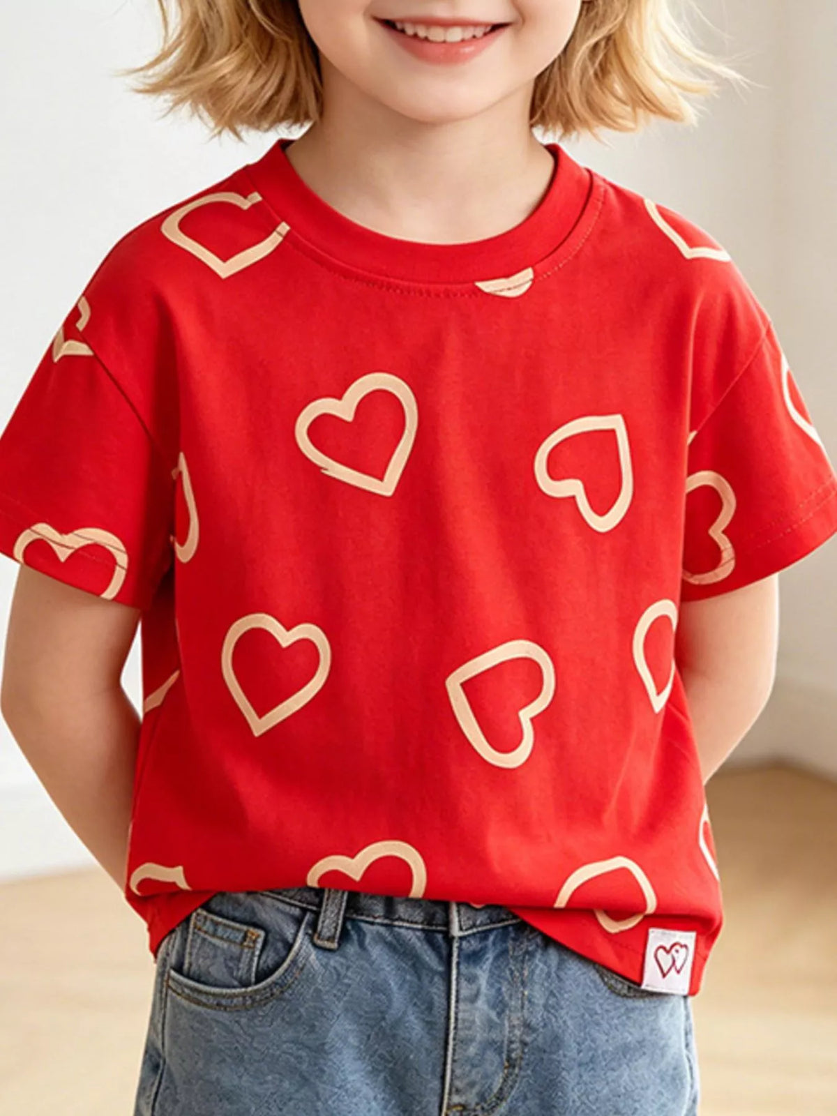 Red outline heart print shirt — shirt shown on child