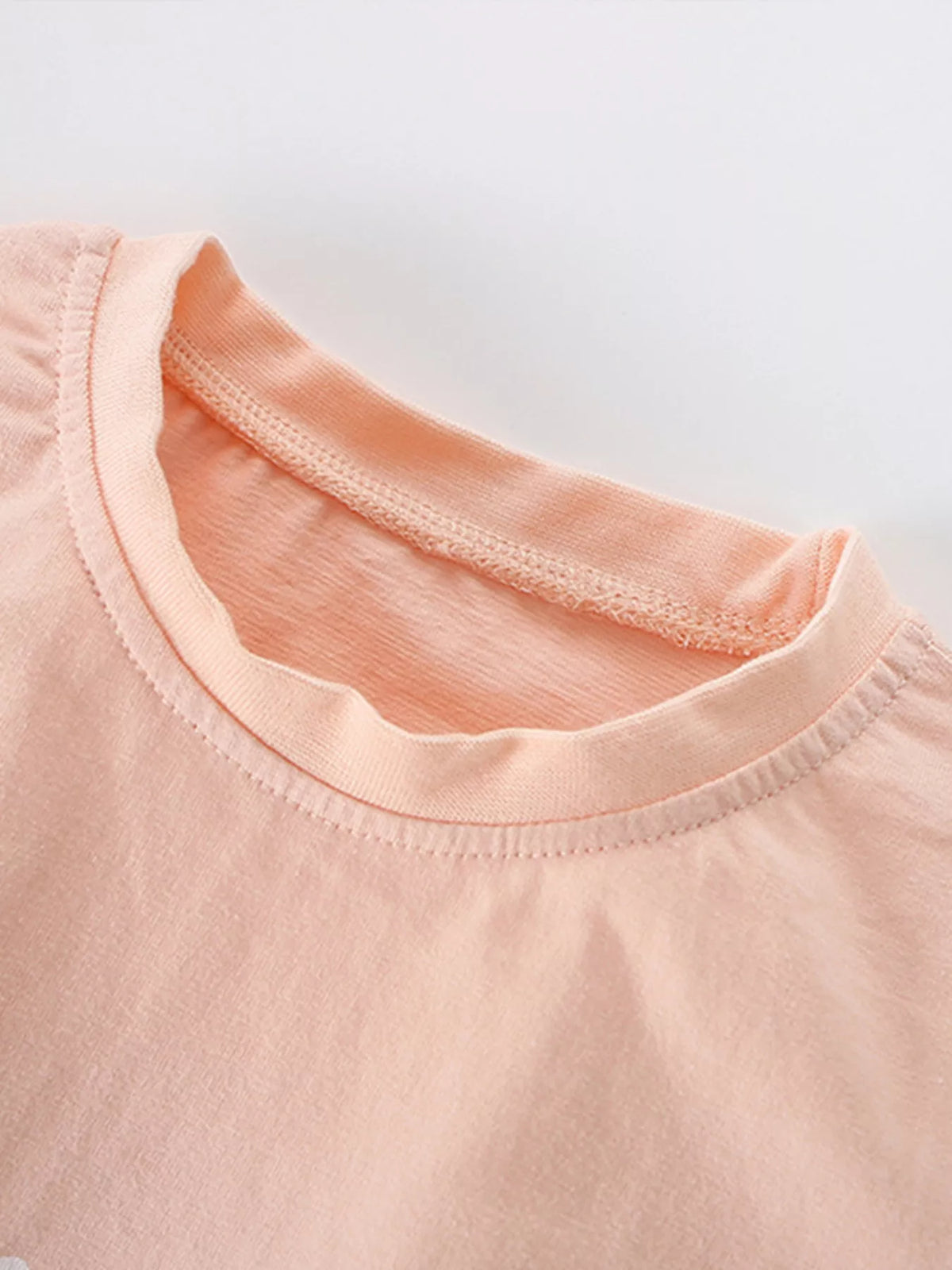 Peach stacked safari animal graphic shirt — round neckline