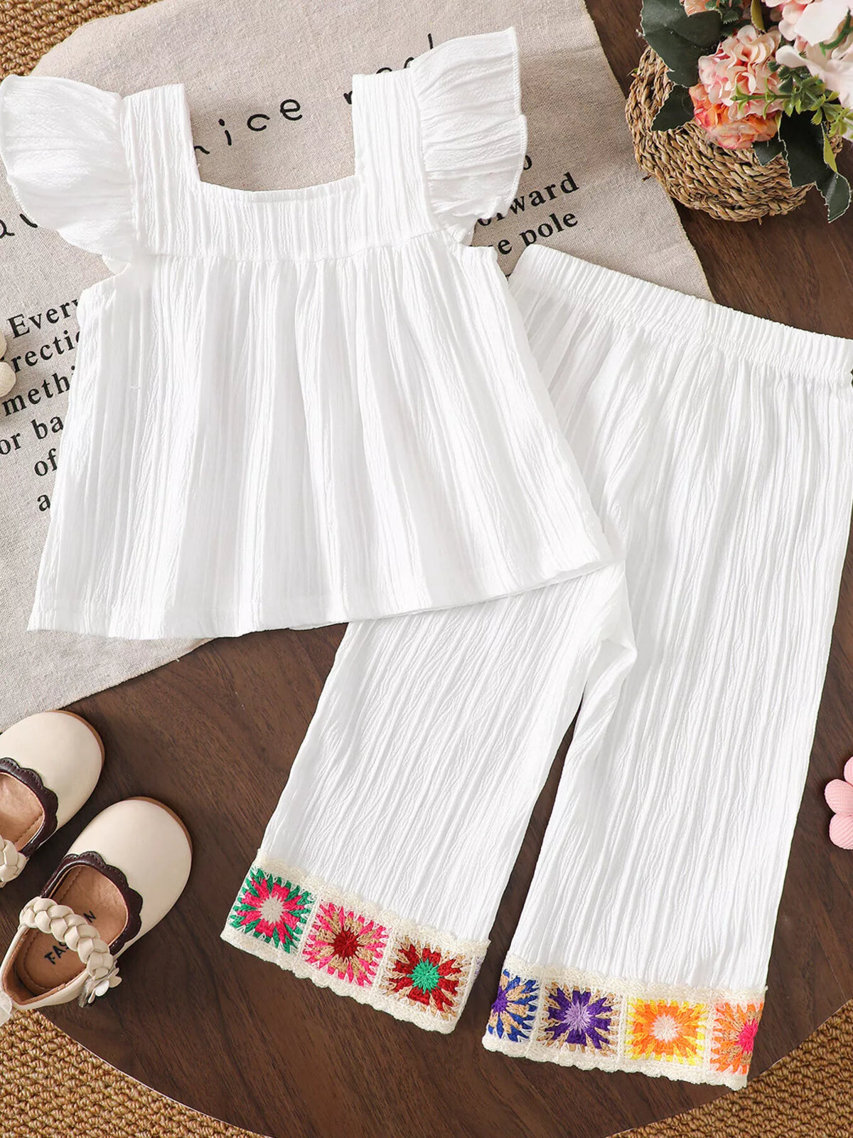 Back of the white top and crochet-trimmed pants