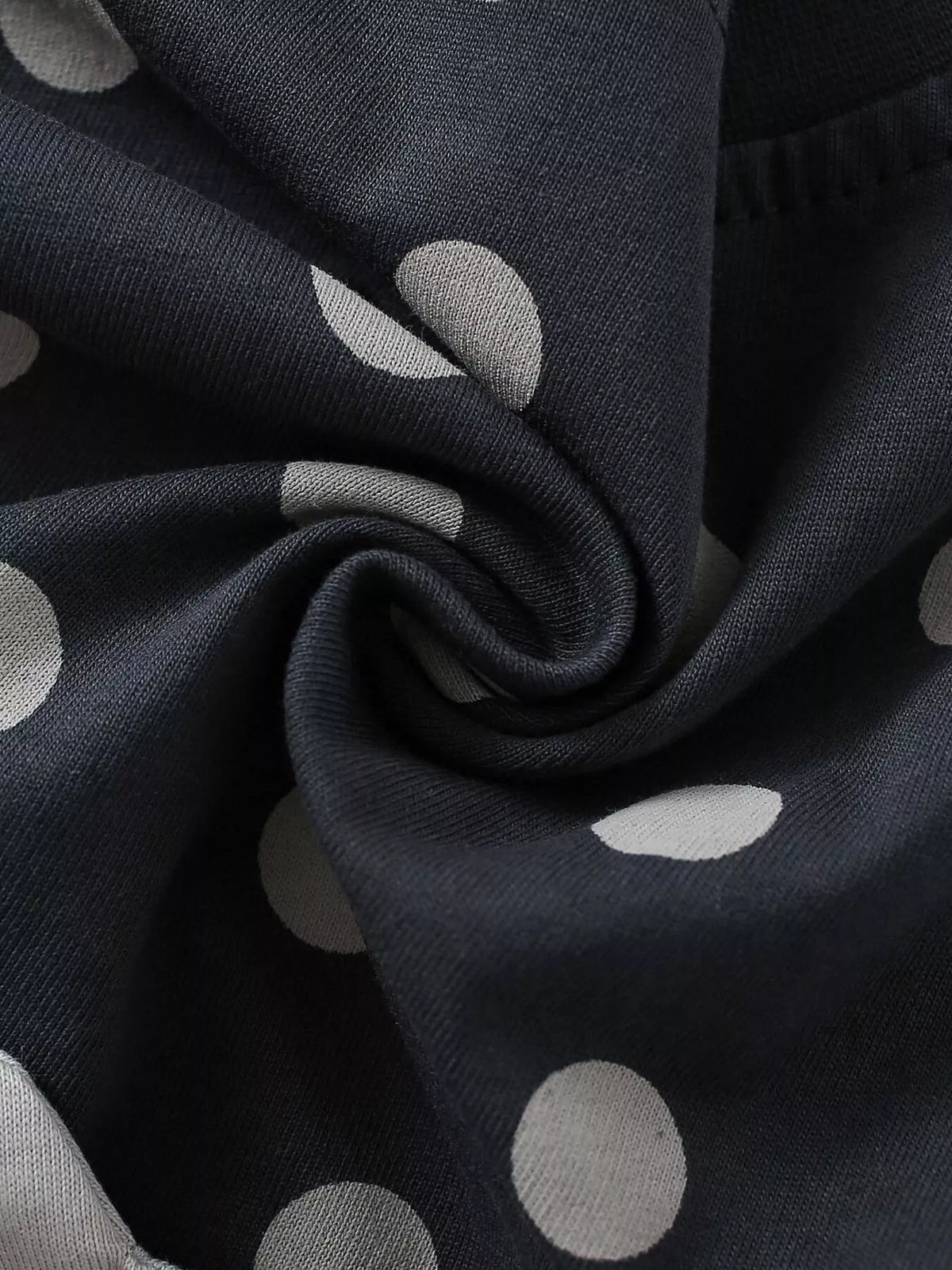 Black fabric with pale polka dots