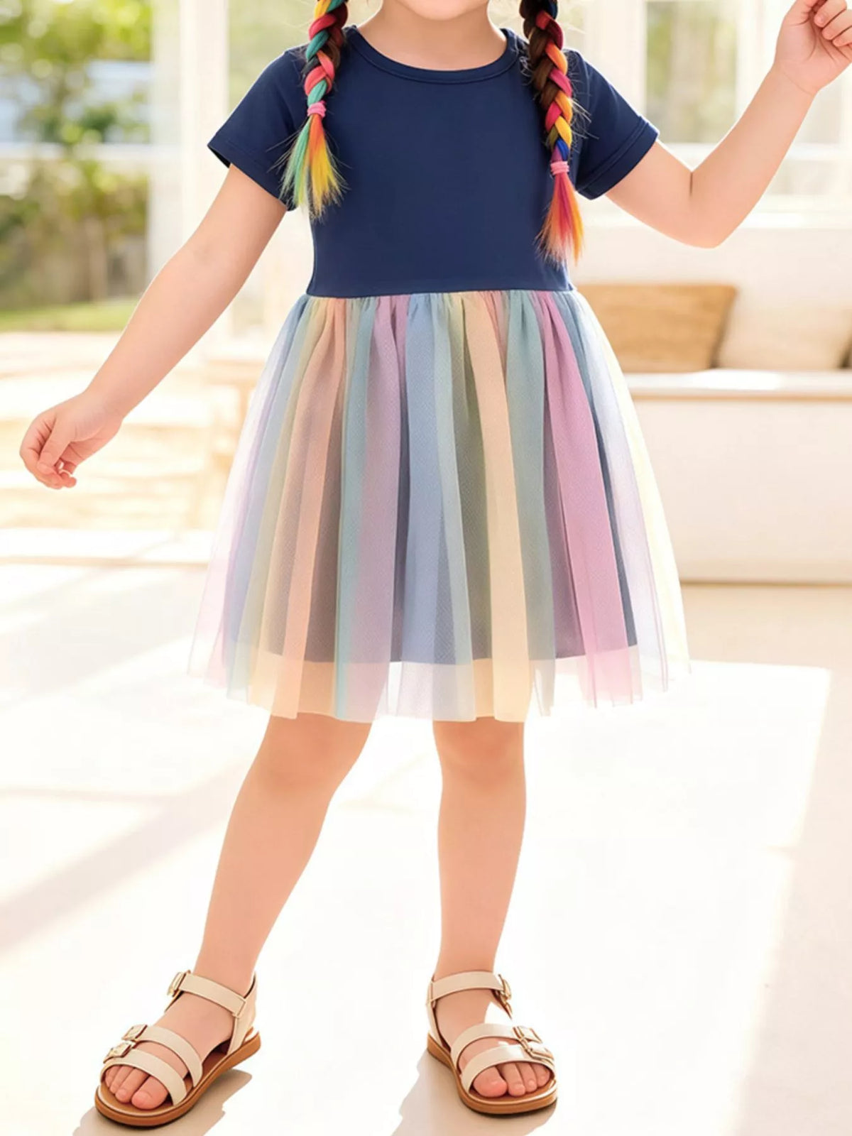 Navy short-sleeve dress with a rainbow tulle skirt on a child