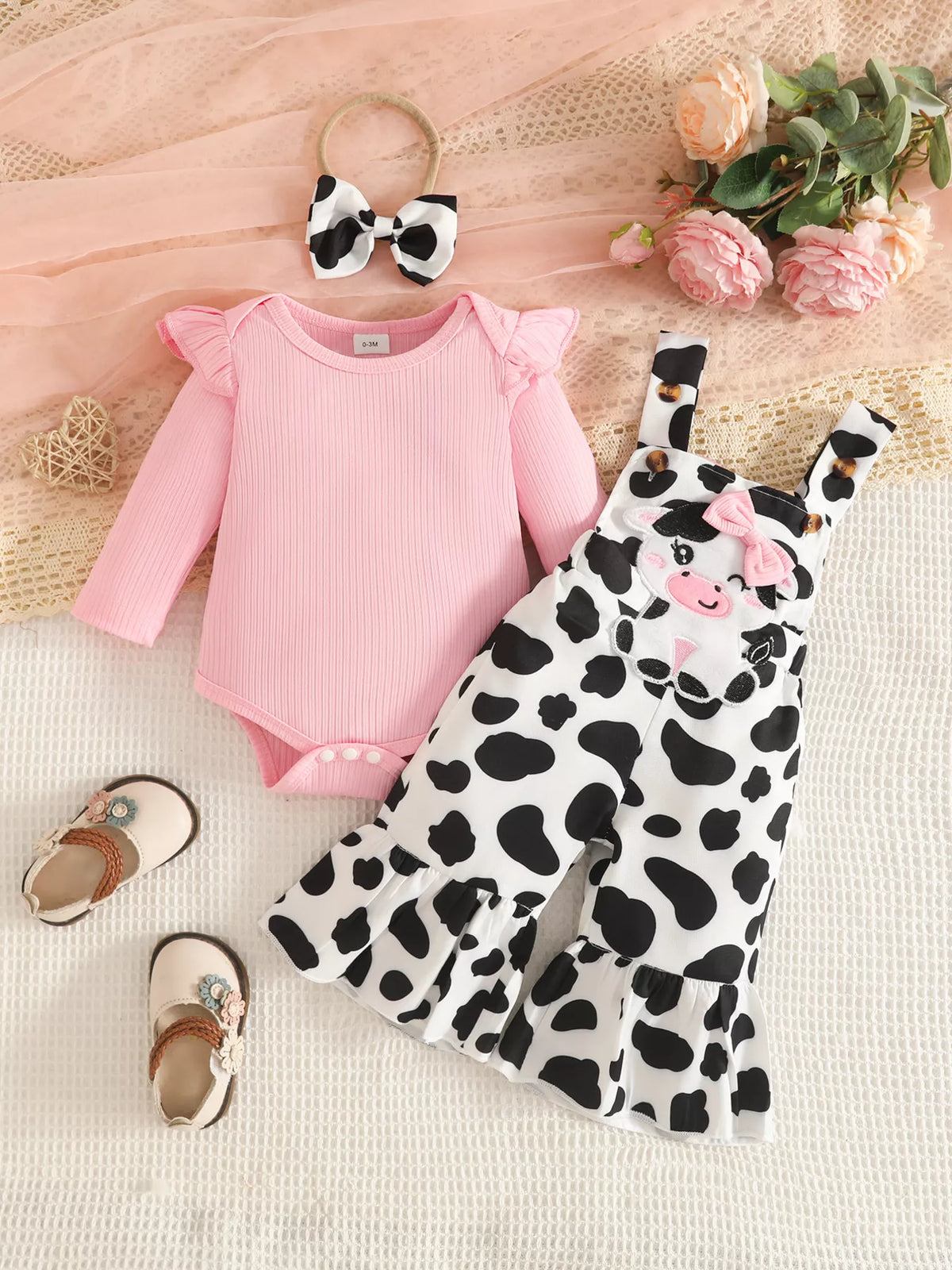 Pink bodysuit cow print ruffle overalls and headband — full outfit front