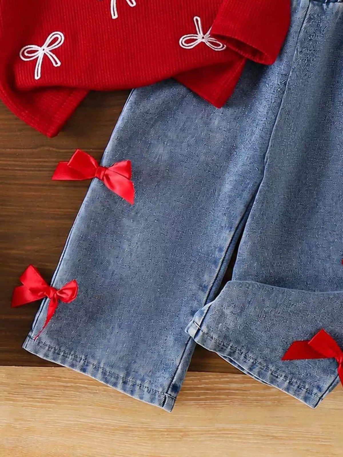 Red Bow Sweater and Jeans Set — jeans with red bows close-up
