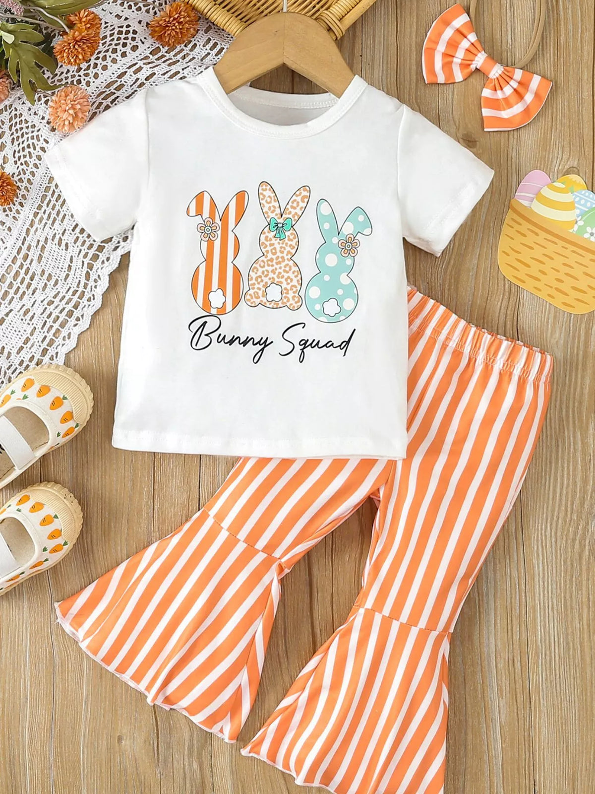 Outfit laid flat with orange striped bow headband