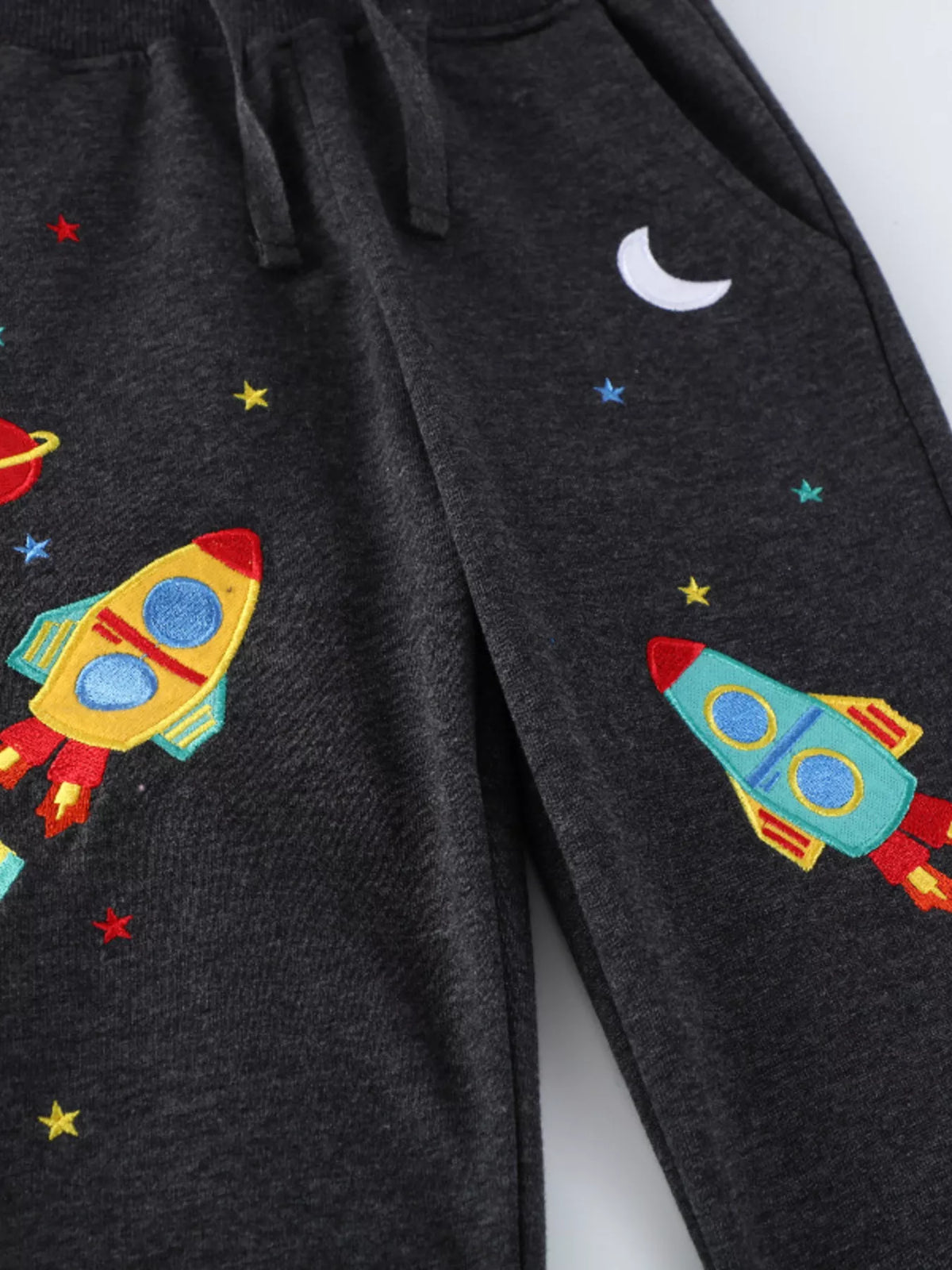 Colorful rockets, stars and crescent moon on the legs