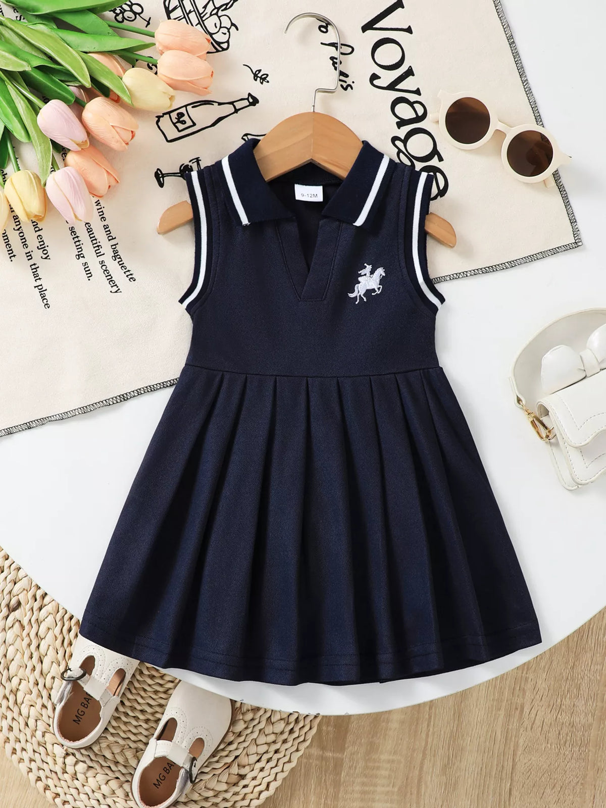 Baby Sleeveless Pleated Polo Dress — front hanging view
