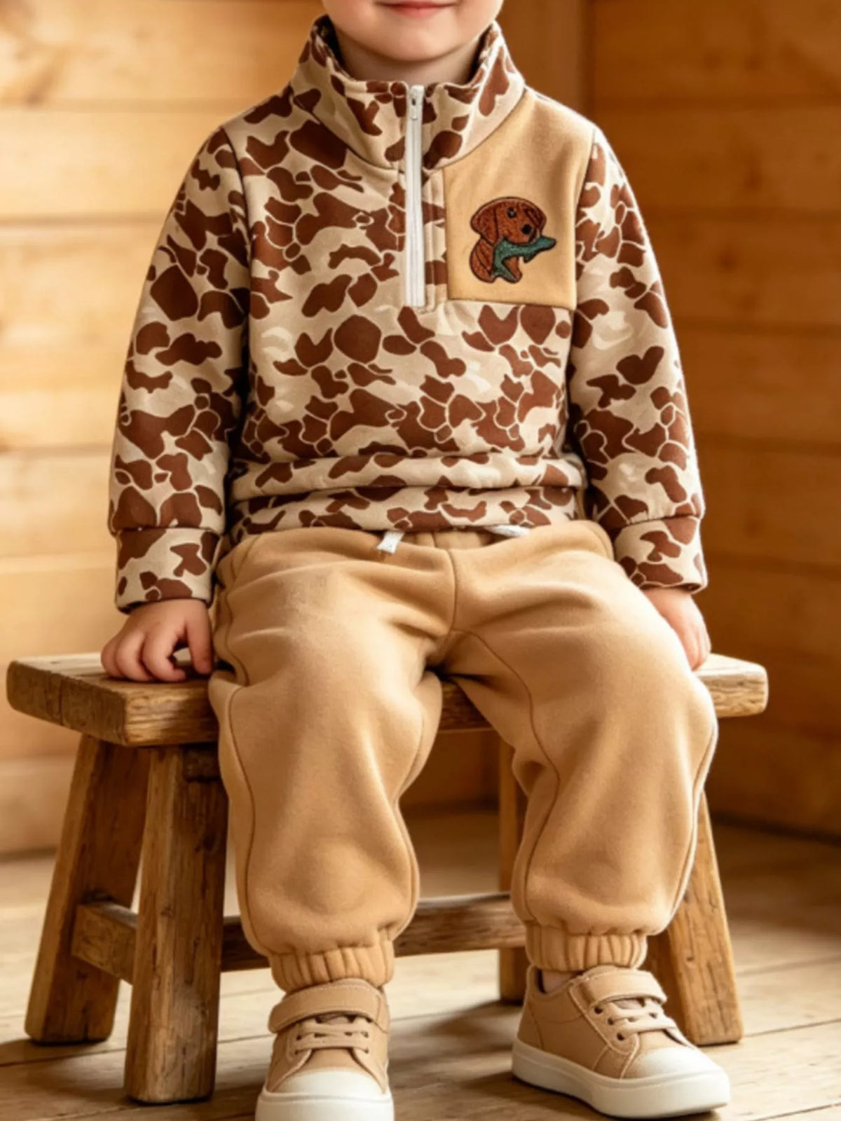 Brown camouflage outfit on a seated child
