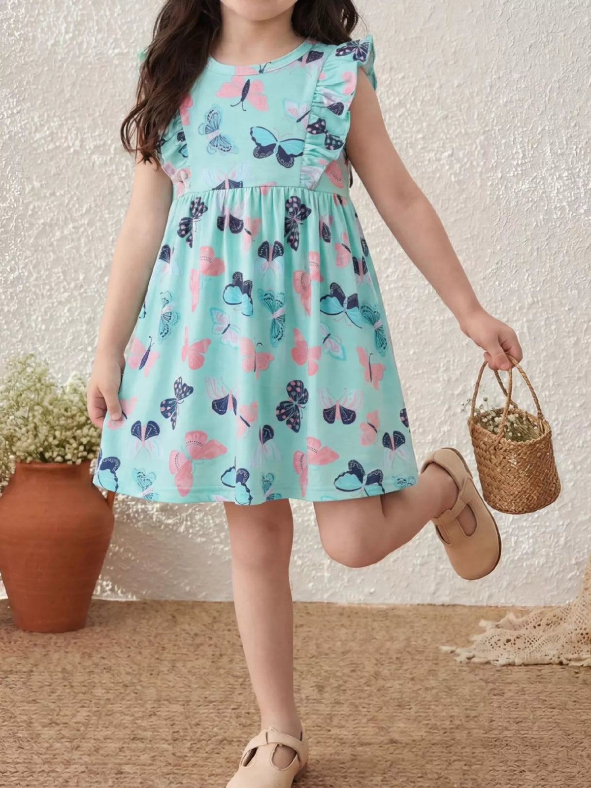 Aqua butterfly-print dress with ruffled sleeves on a child