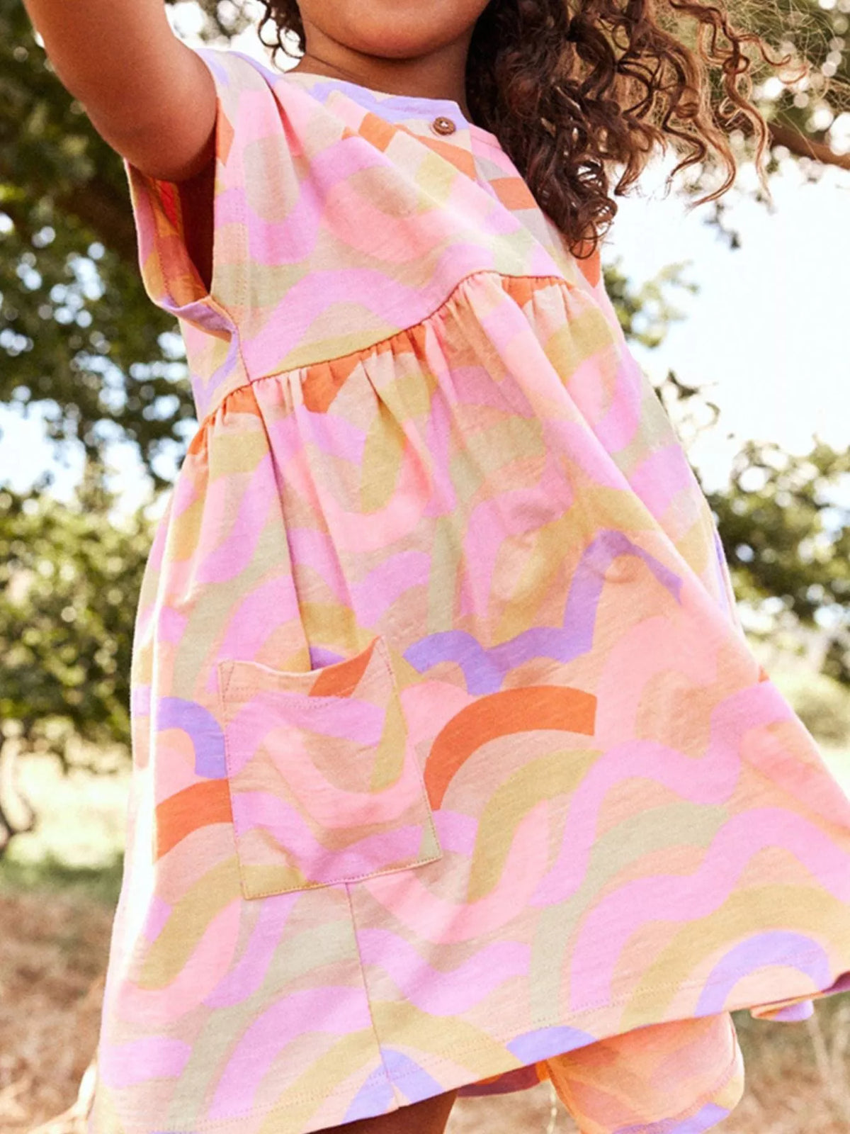 Wavy Rainbow Button-Front Dress — dress worn by a child