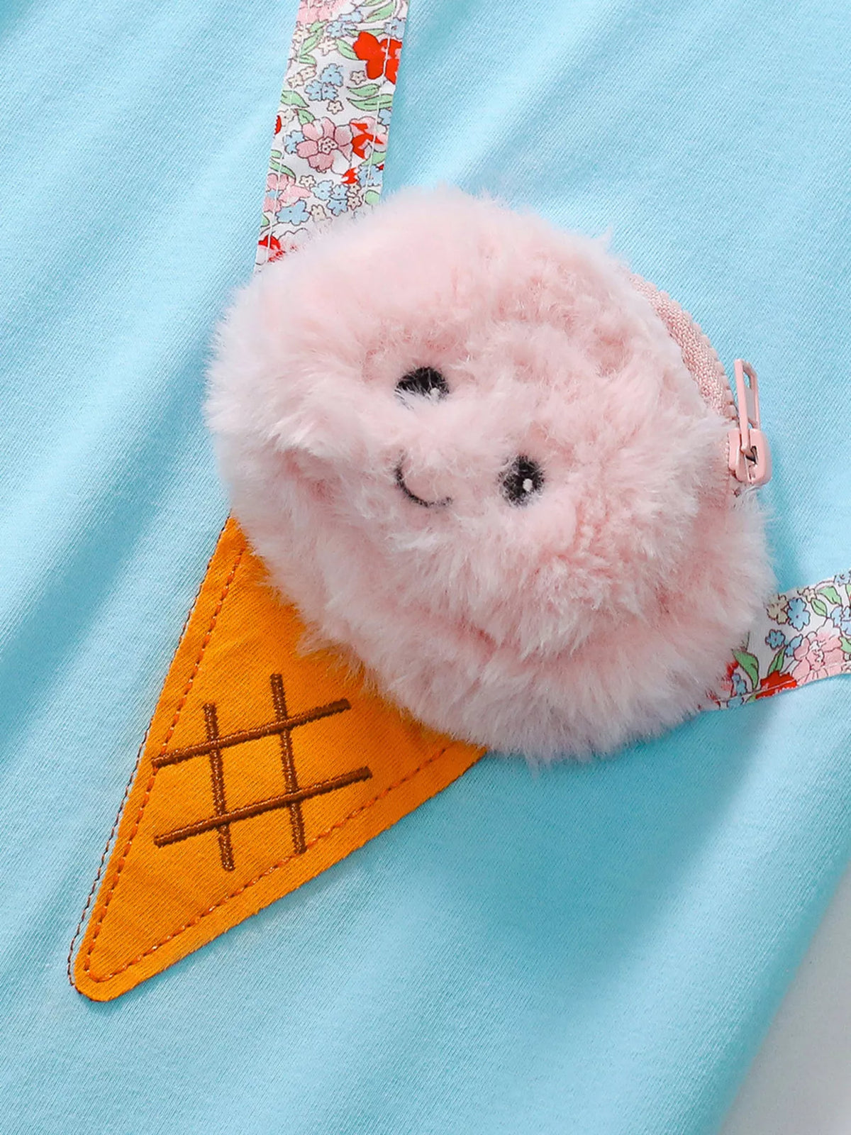 Textured pink ice-cream scoop and orange cone with a floral strap detail