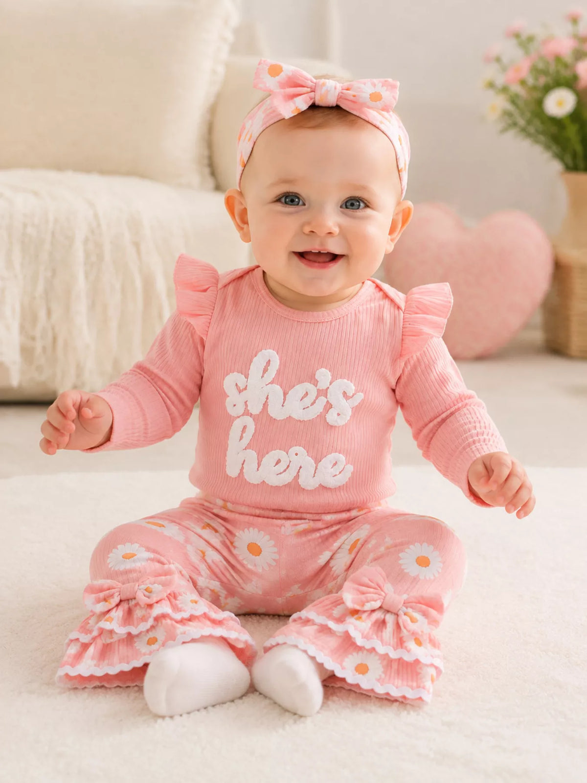 Outfit and headband on a seated baby