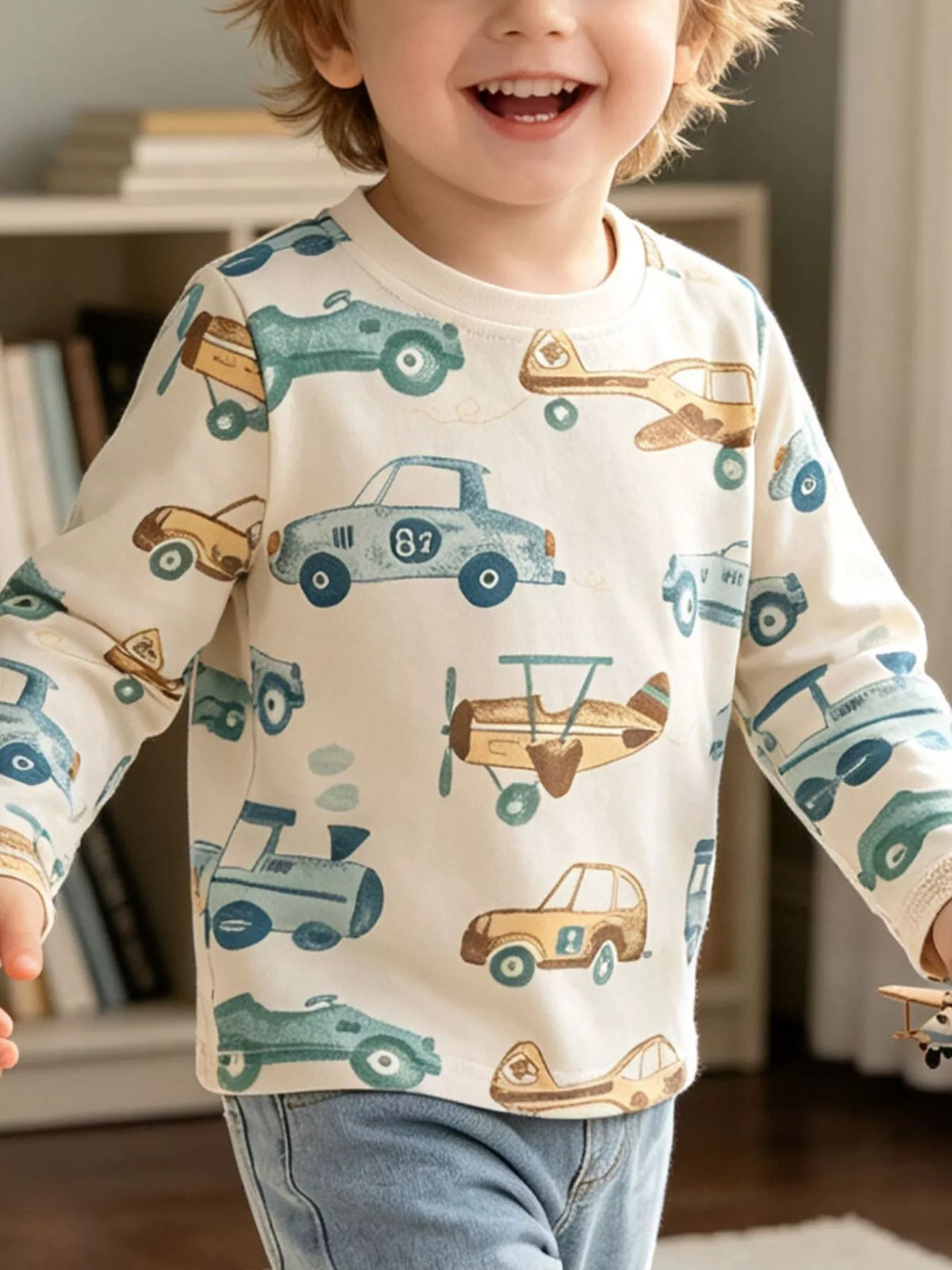 Cream long-sleeve tee with cars and airplane print on a child