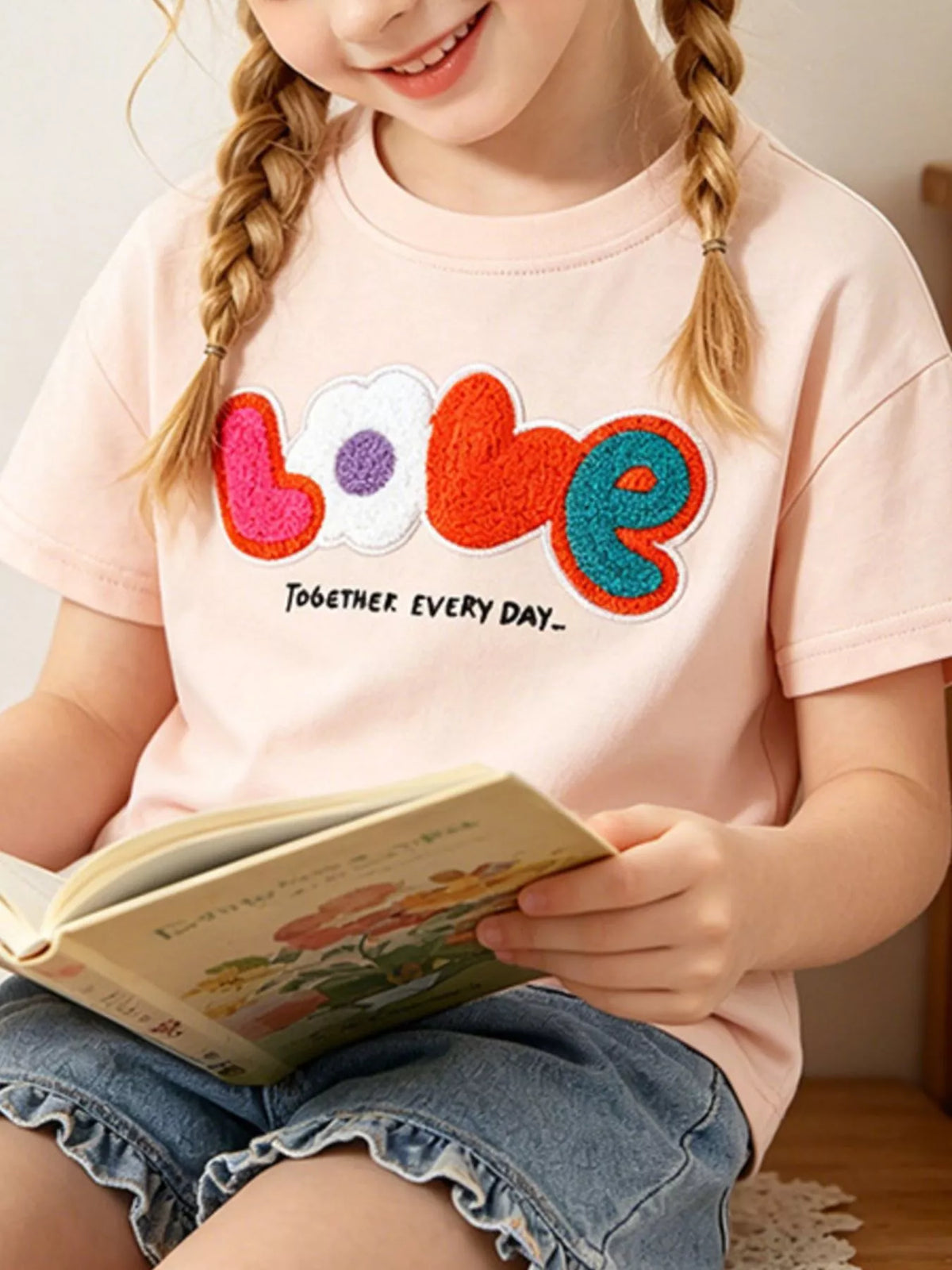 Peach LOVE applique shirt — shirt shown on child