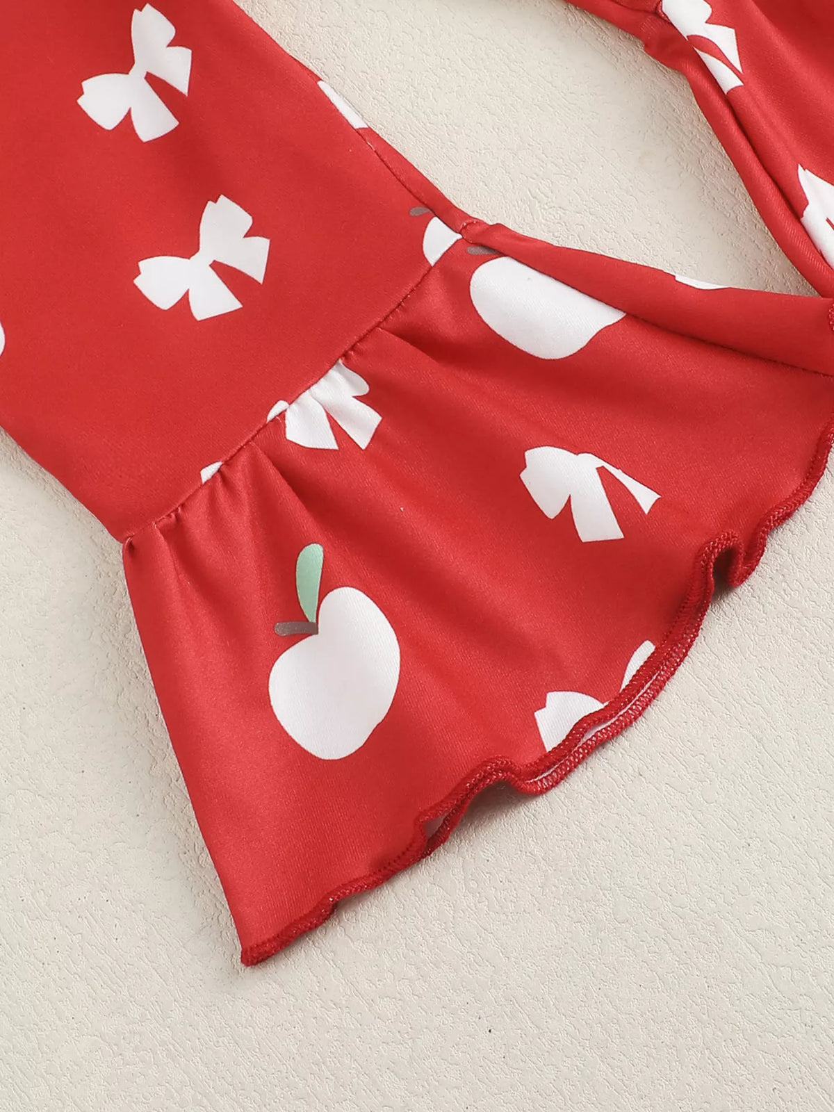 White ribbed apple bodysuit red flare pants and headband — flared printed pants hem