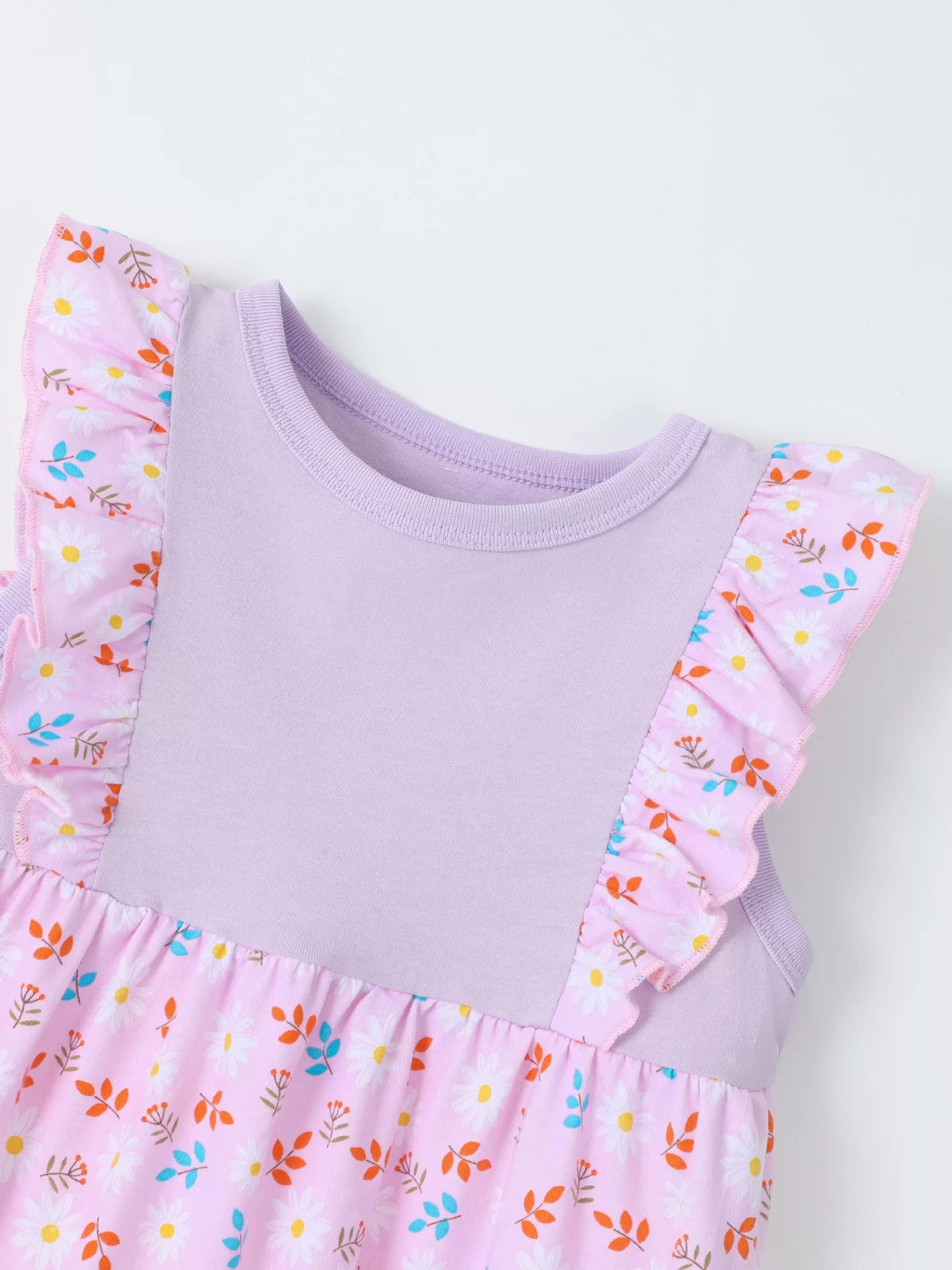 Round neckline and floral shoulder ruffles