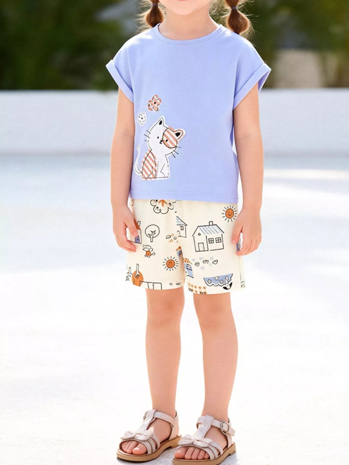 Blue cat tee with cream printed shorts on a child