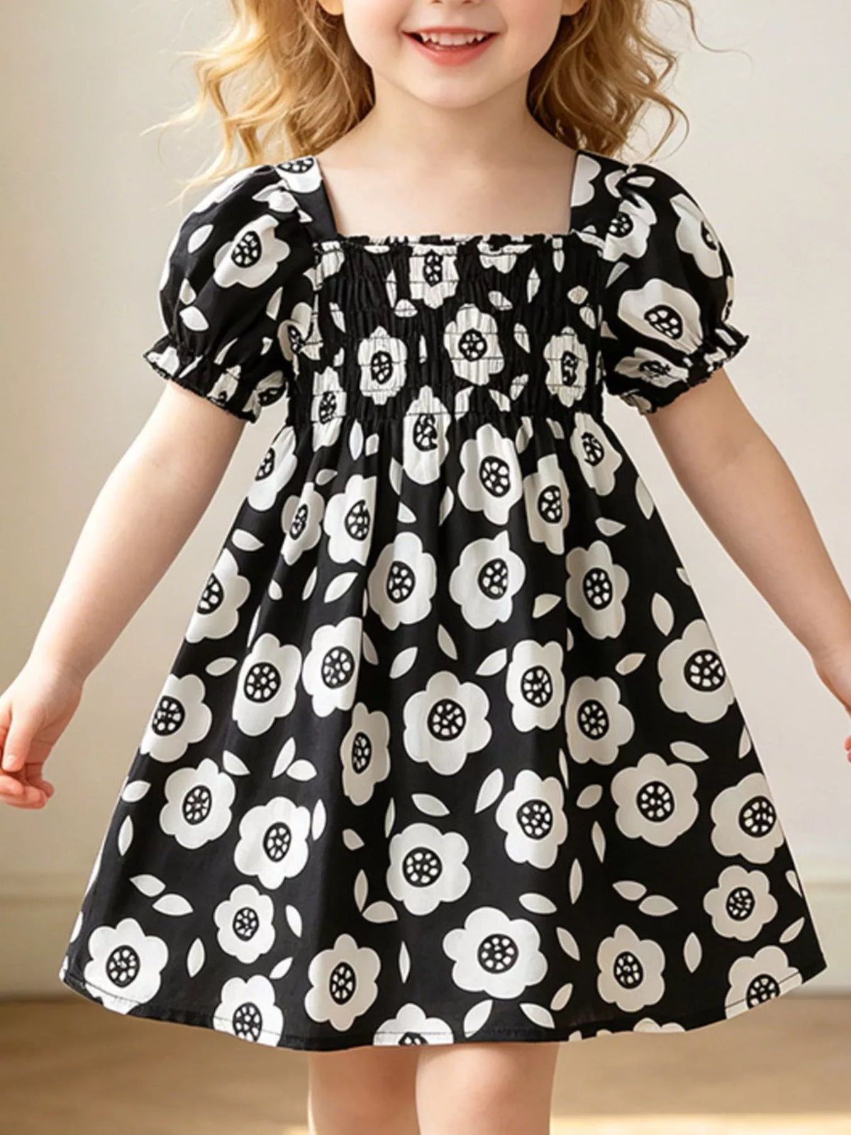 Black floral square-neck dress with puff sleeves on a child