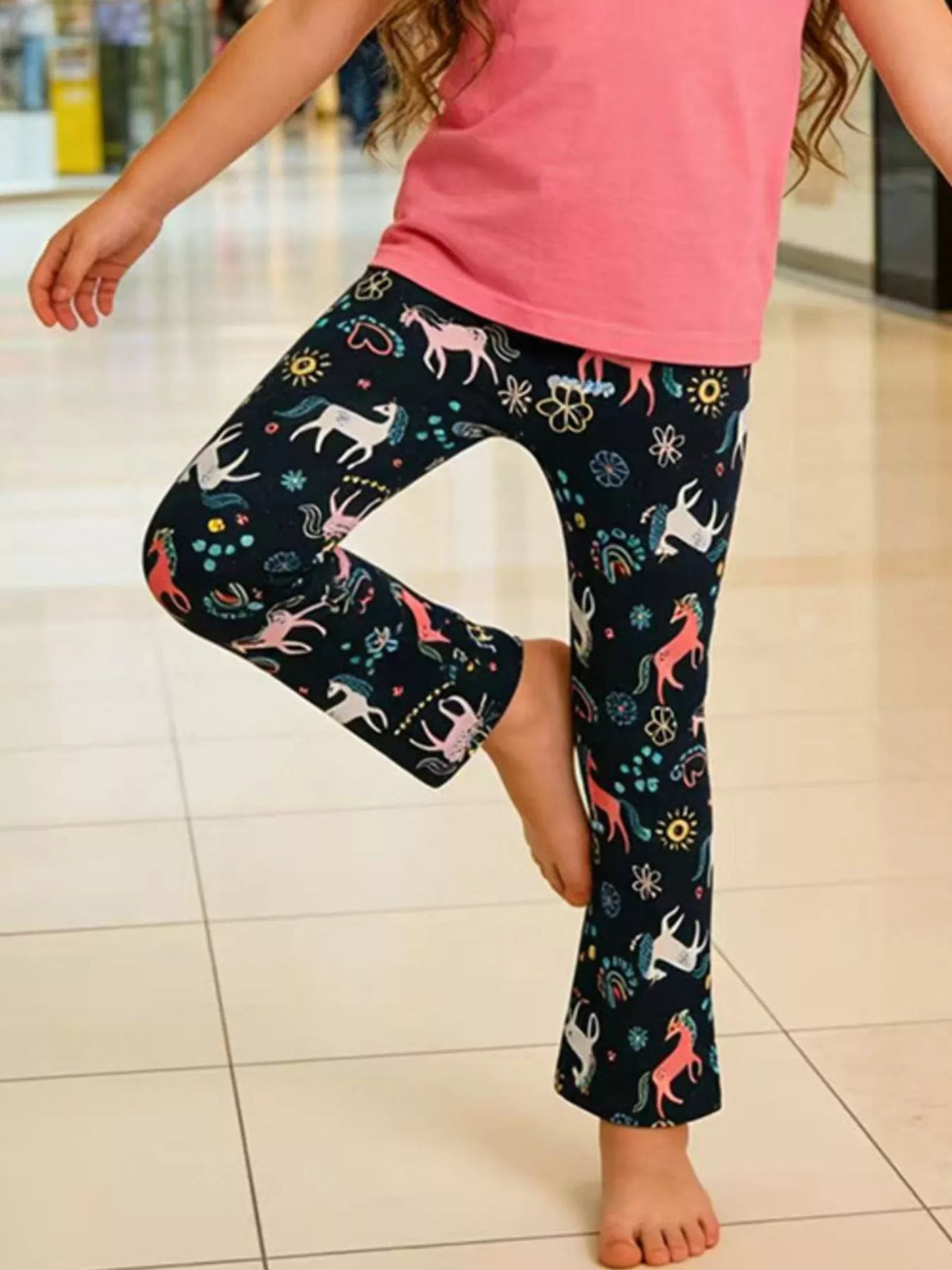 Navy unicorn-print flared leggings on a child