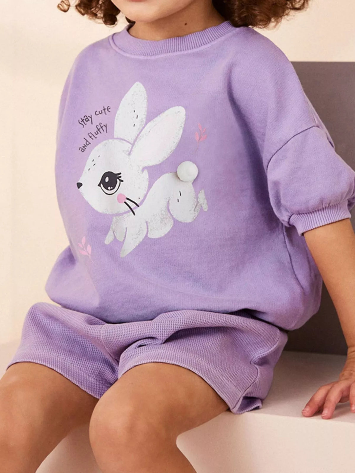 Bunny top and shorts on a child viewed at an angle