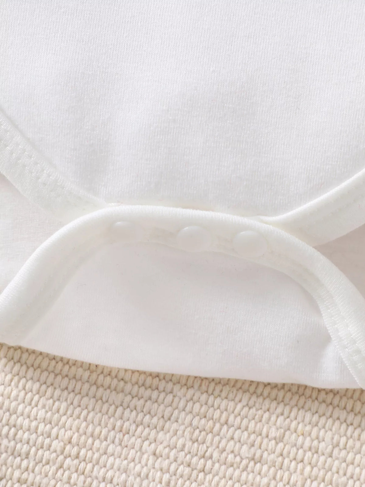 Snap closure on the white bodysuit