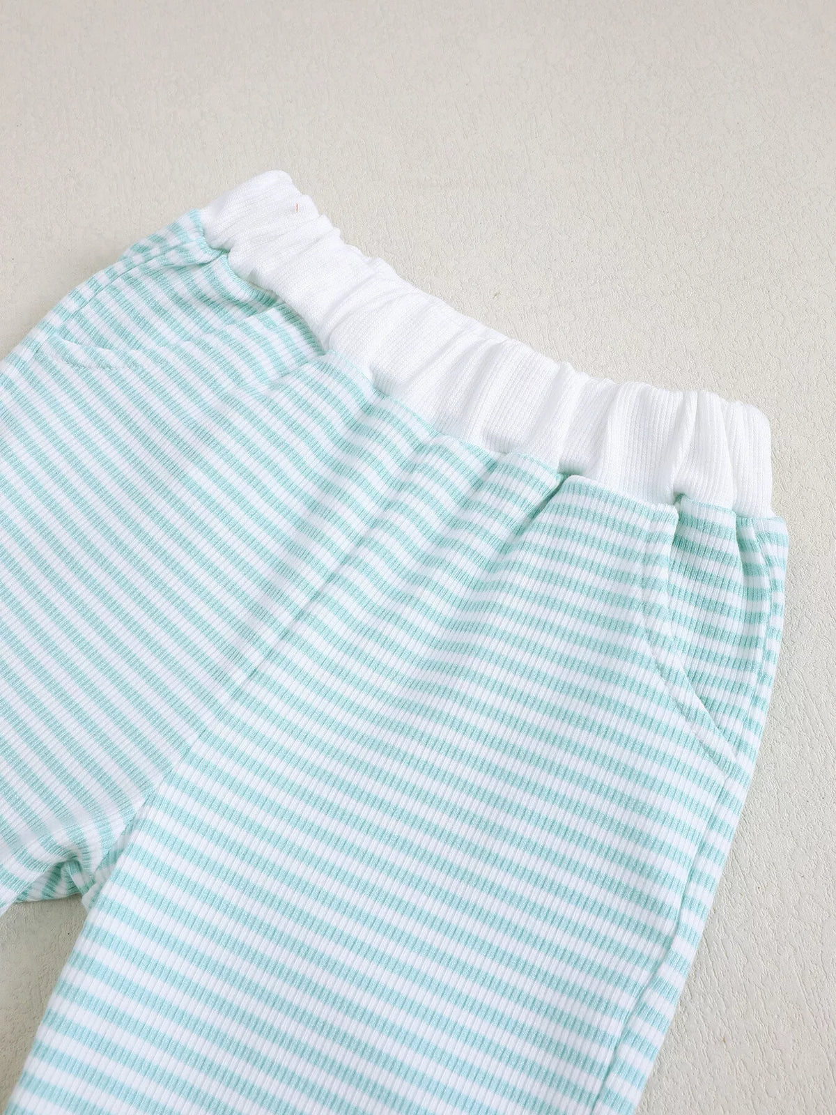 White elastic waistband on pale blue striped pants